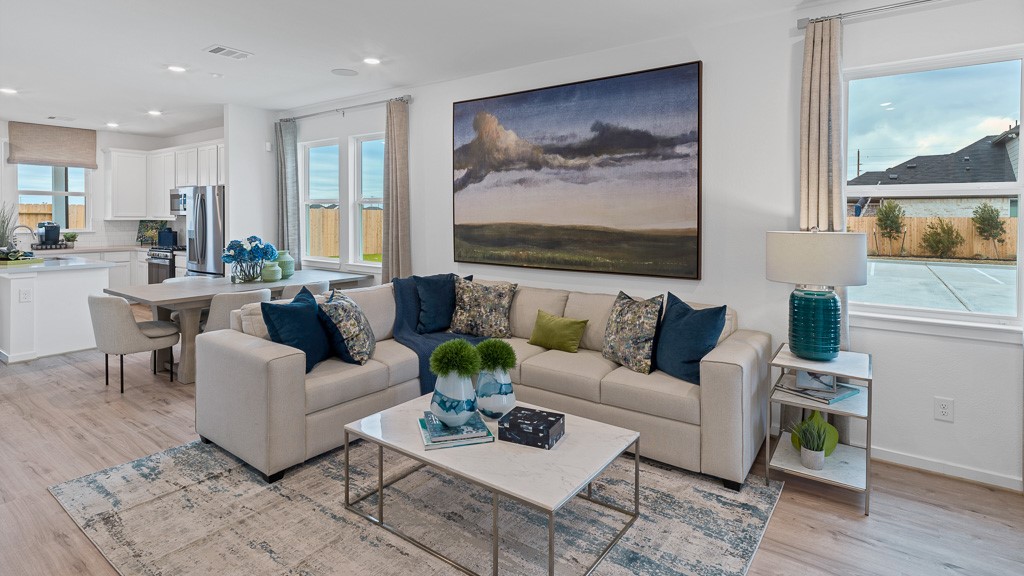 Beautiful natural lighting in family and dining room with expansive windows and custom drapery.