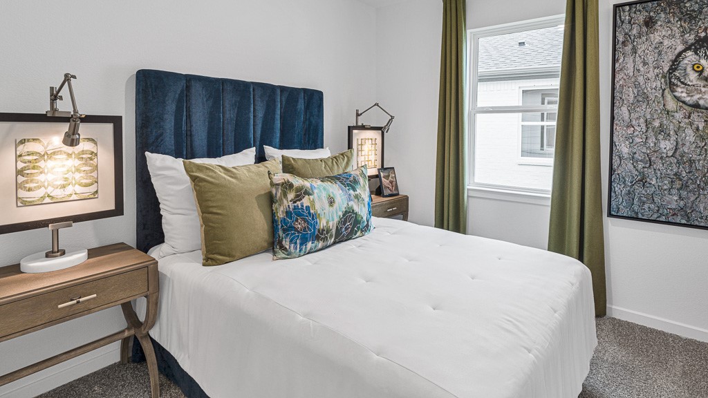 Bedroom 3 has upscale style with a beautiful window and custom drapery.