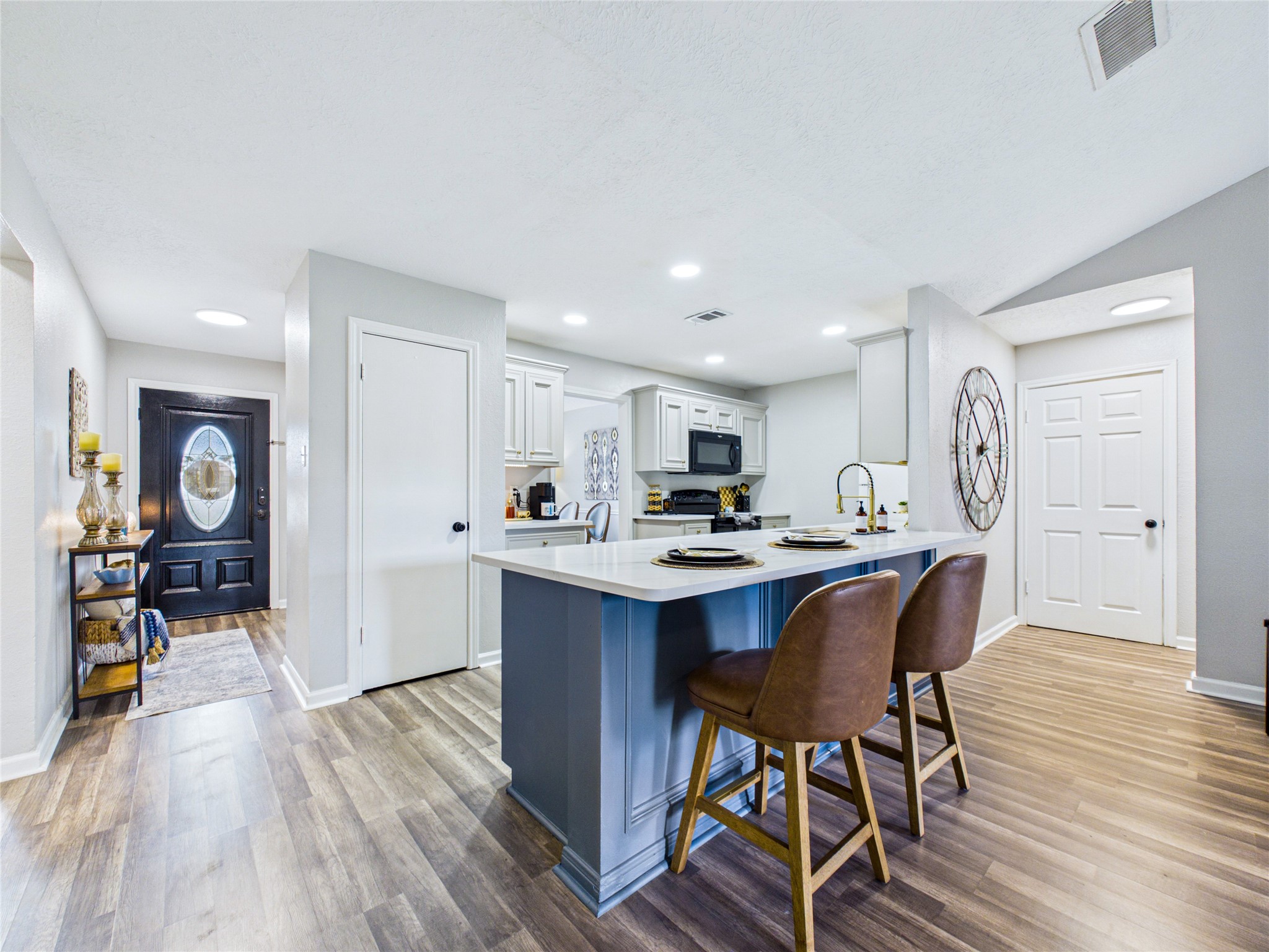 Charming open-concept kitchen with a sleek breakfast island, modern appliances.