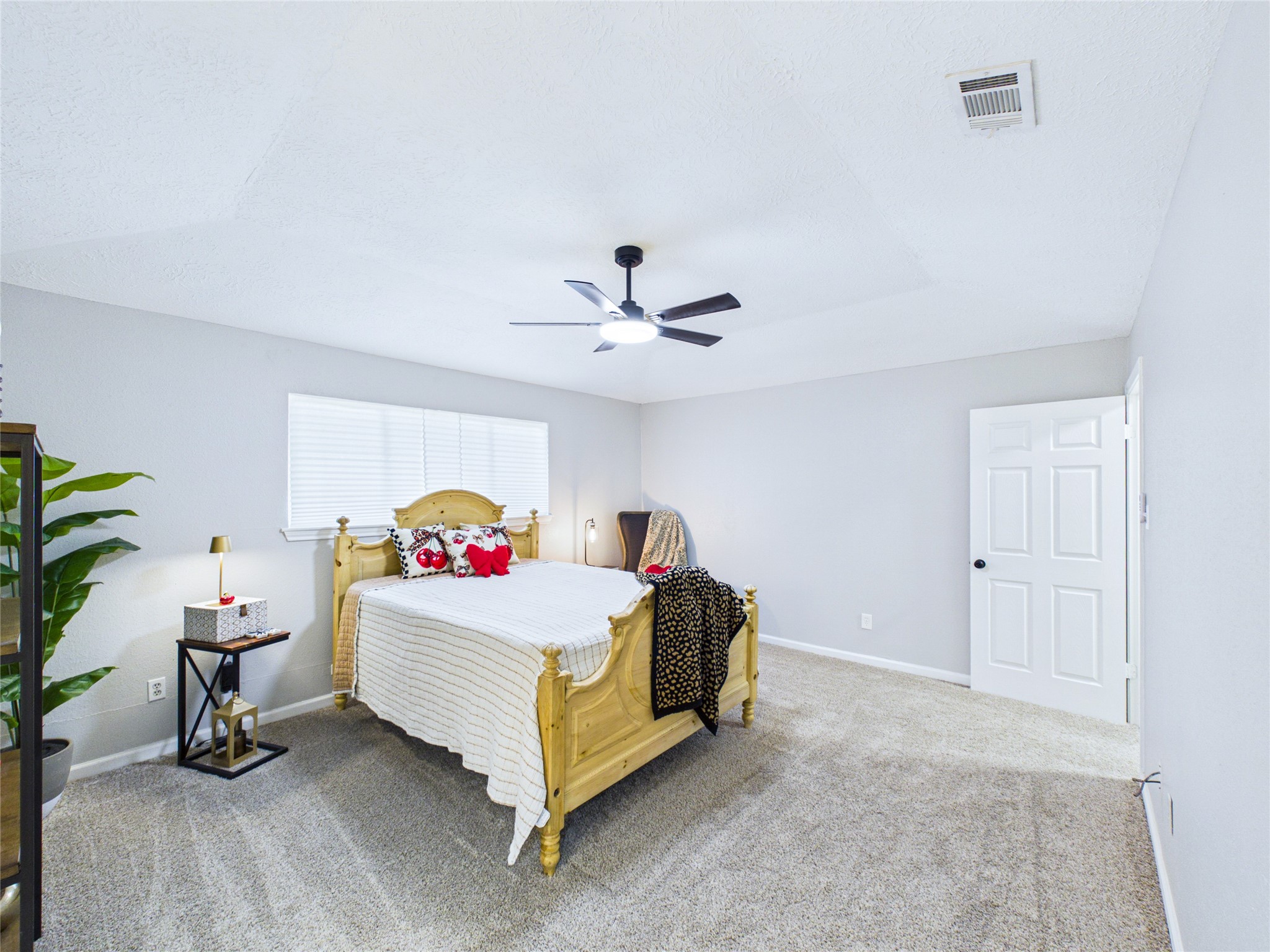 Another view of the Primary Bedroom showing all the room and light it has.