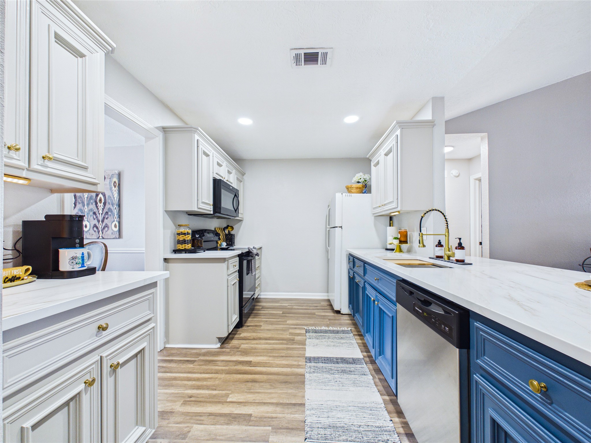 Bright and inviting kitchen with modern cabinetry including brand new door handles and cabinet pulls.
