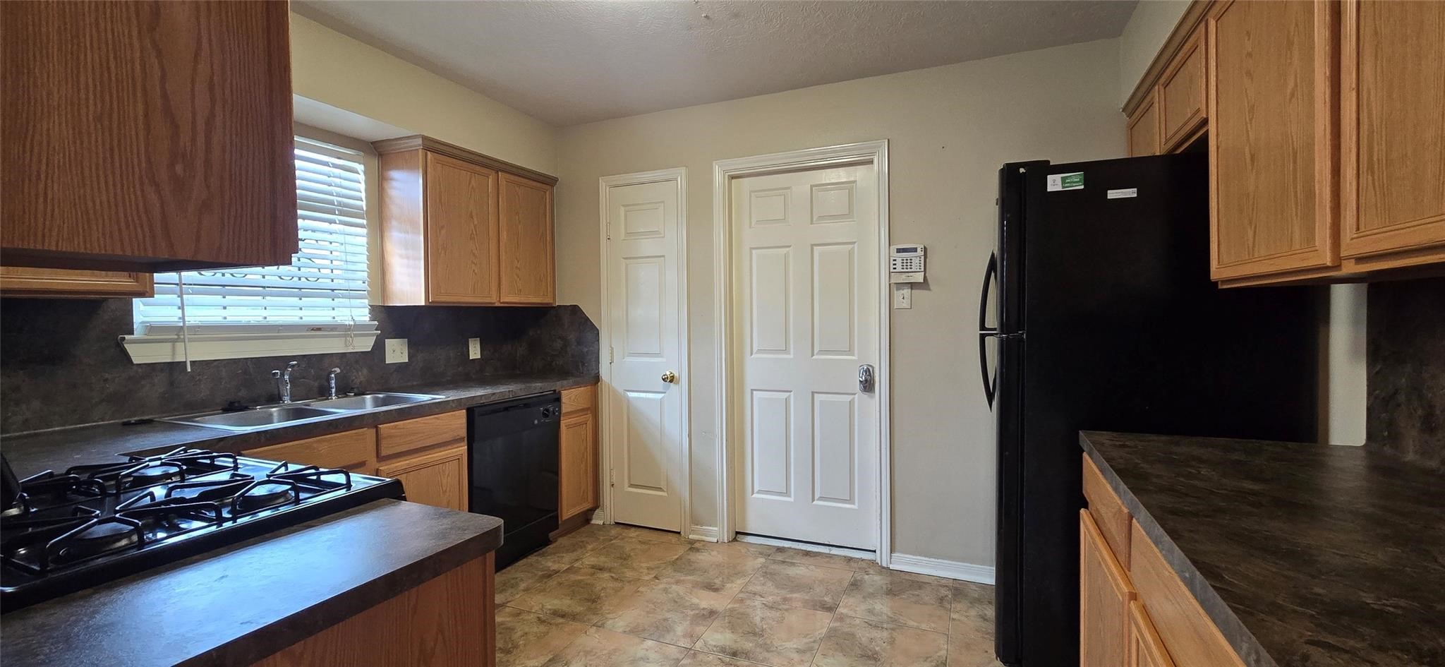 Refrigerator remains with property.