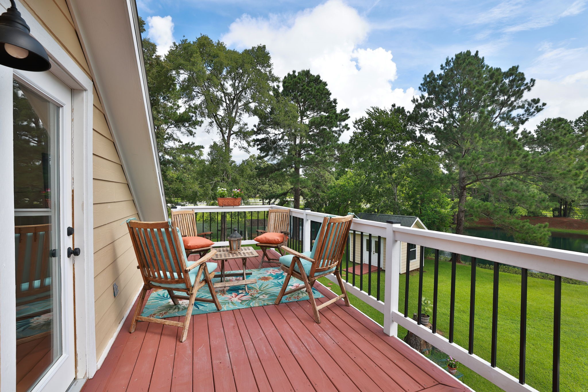 This inviting balcony features a cozy seating area and the most stunning views of the property.  So serene and perfect for relaxing outdoors.