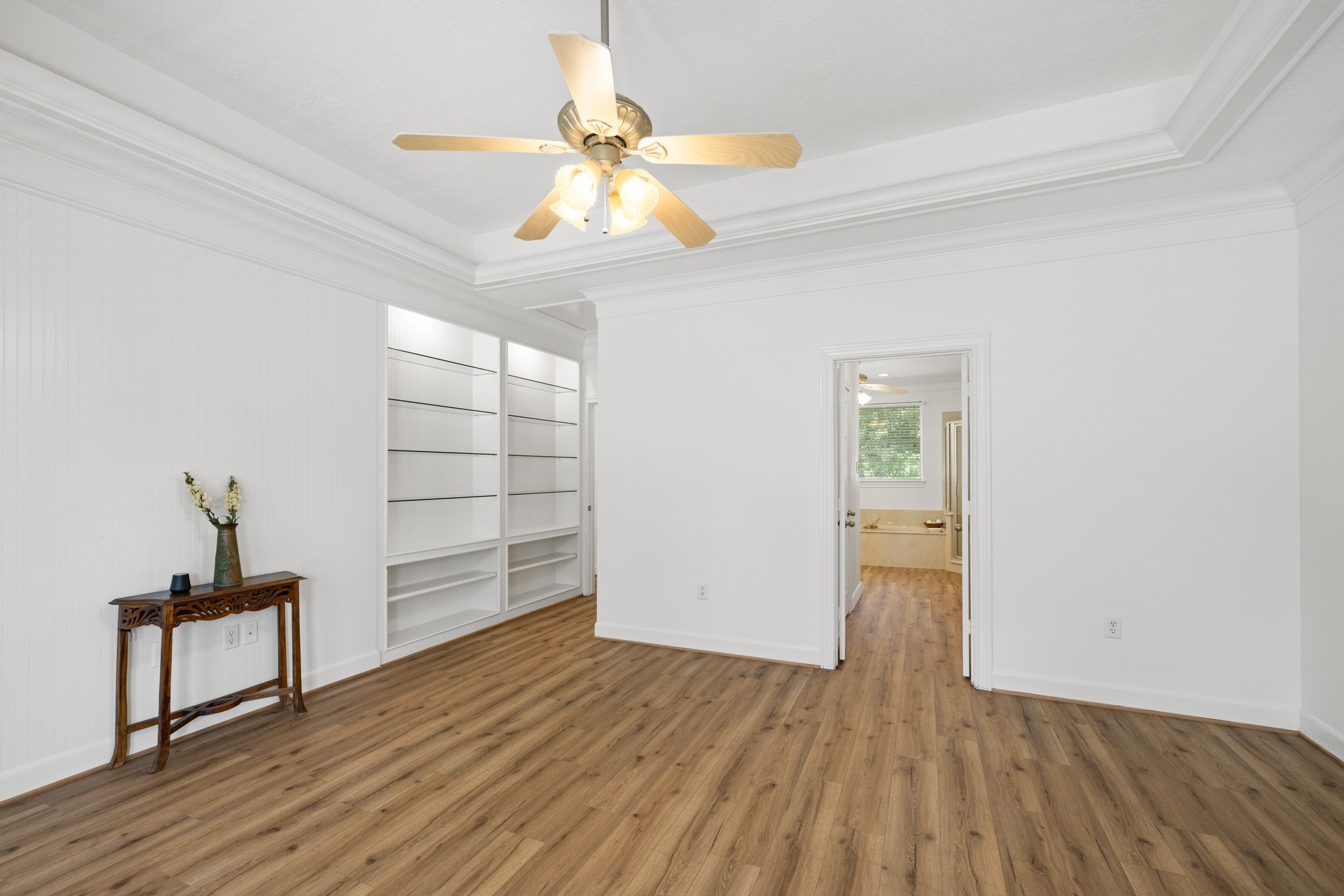 Explore the elegant built-in shelves in the primary bedroom, perfect for showcasing your art and cherished photos.