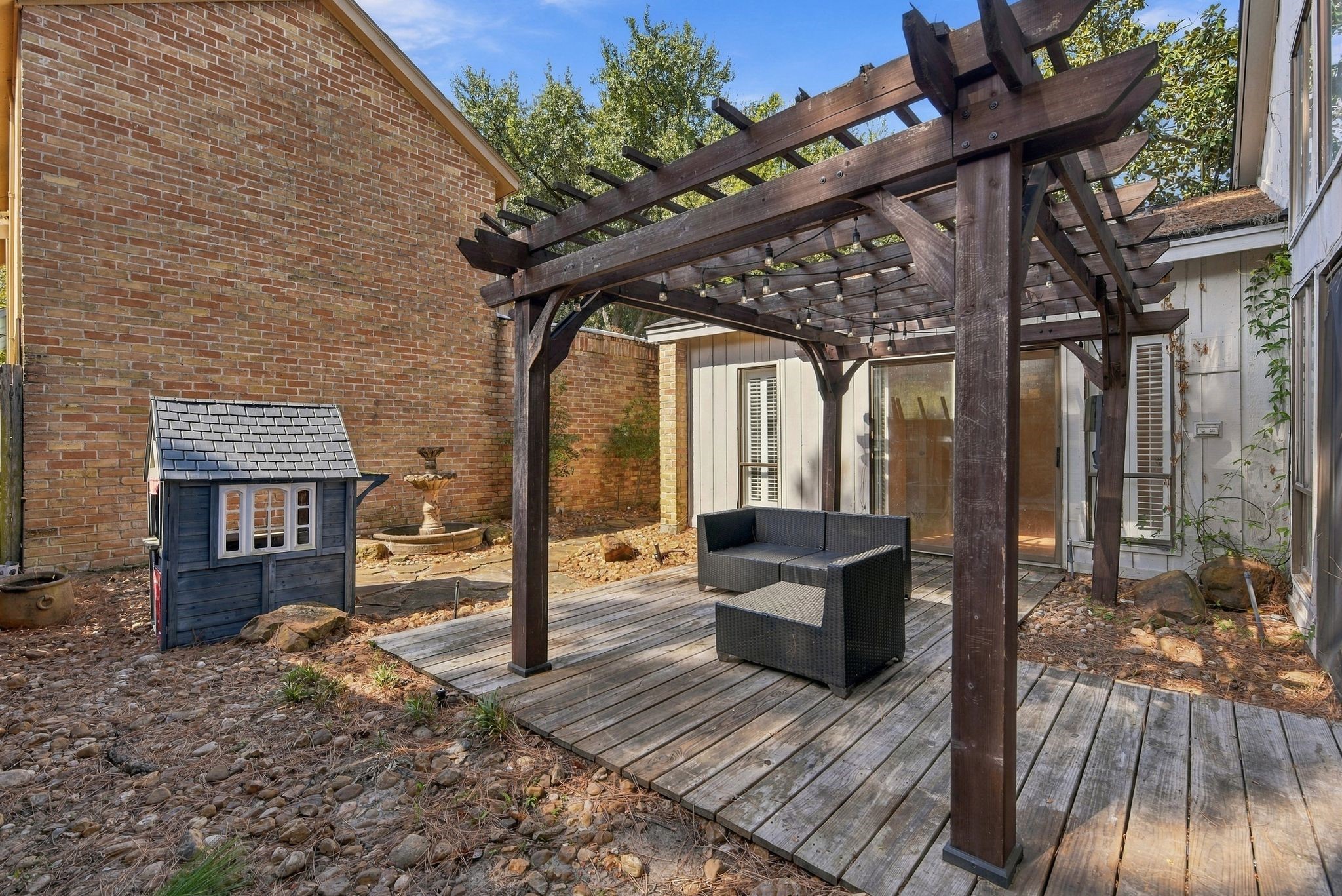 Pergola-covered patio just off the primary suite, offering a peaceful space to relax or entertain.