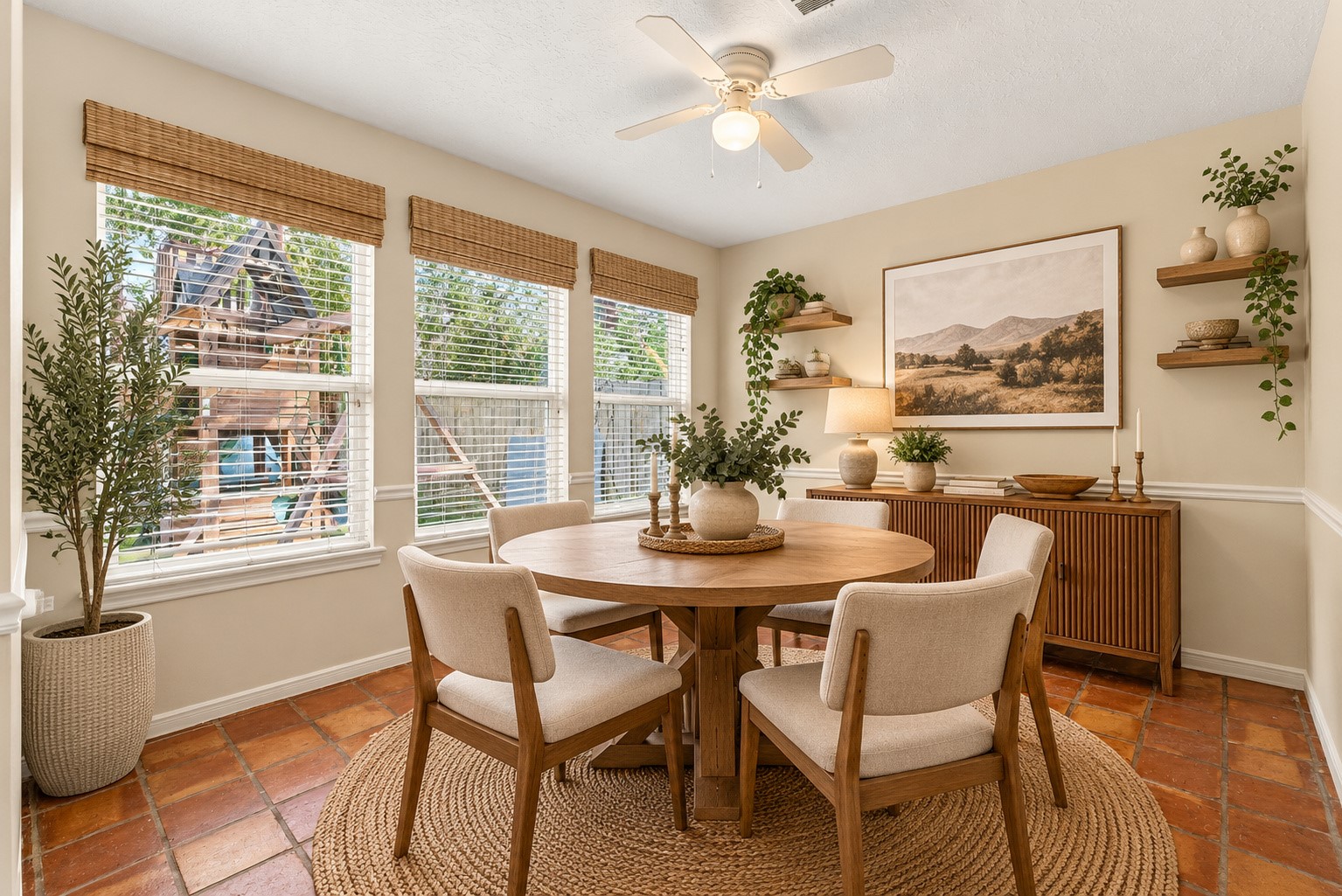 Virtually staged breakfast nook featuring abundant natural light, charming windows, and beautiful Saltillo tile flooring.