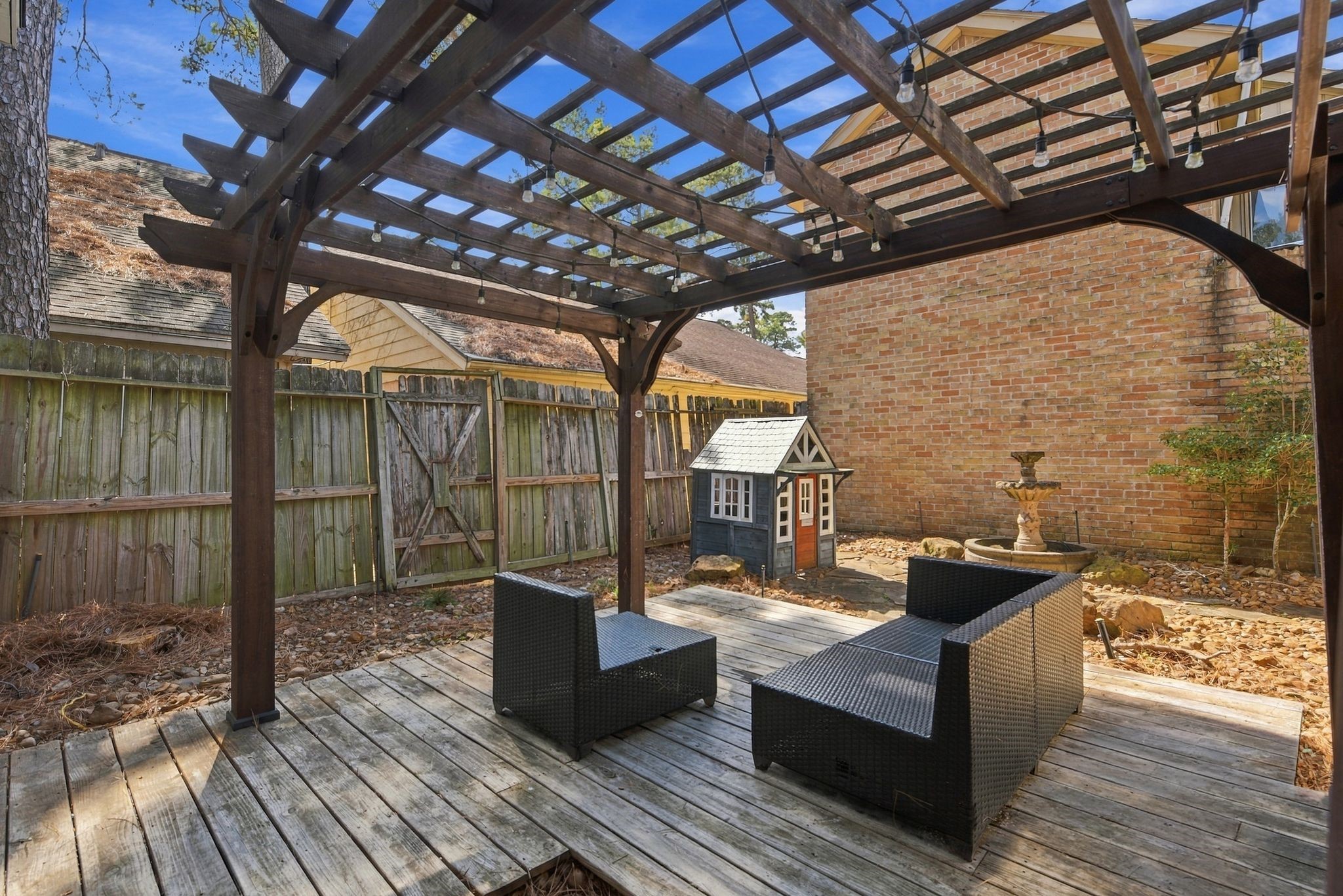 Additional view of the primary suite's private courtyard, featuring comfortable outdoor seating that conveys with the property.