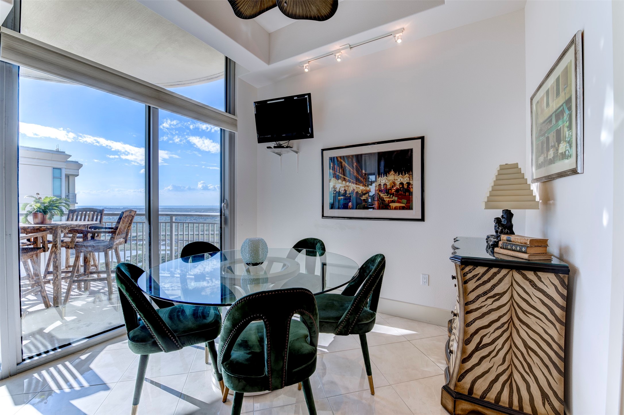 Bright breakfast area sits beside the balcony, with floor-to-ceiling glass and open views beyond Bright breakfast area sits beside the balcony, with floor-to-ceiling glass and open views beyond