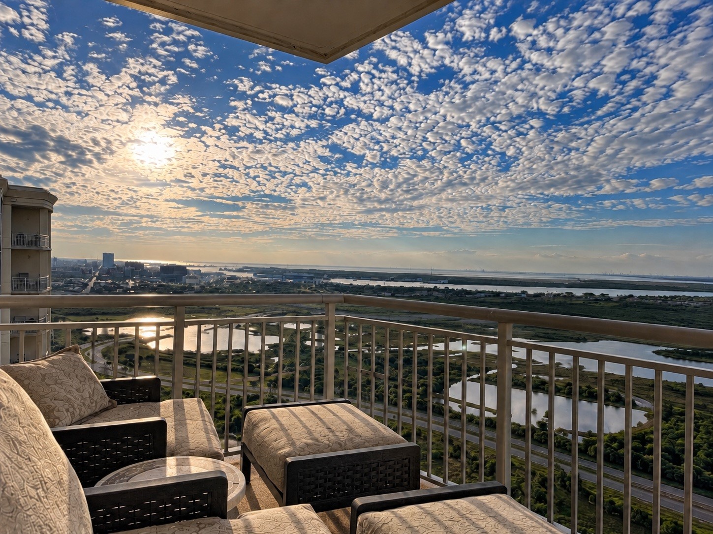Looking west from the north-facing balcony extends the living space outdoors, with westward views across the bay, wetlands and city.