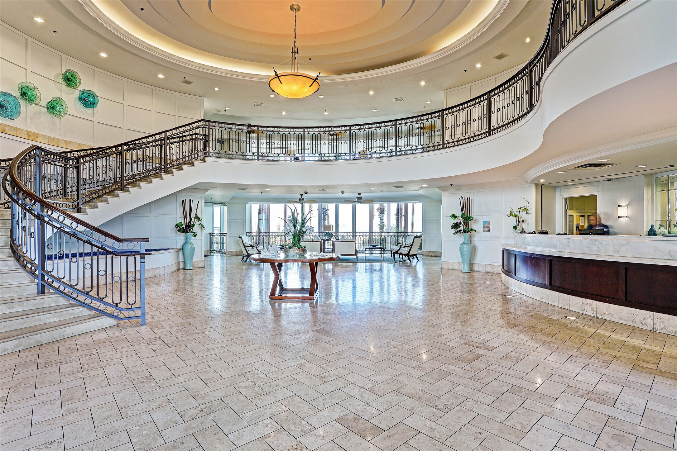 The elegant two-story lobby welcomes you with sweeping views, timeless coastal style, and the ease of 24/7 concierge service