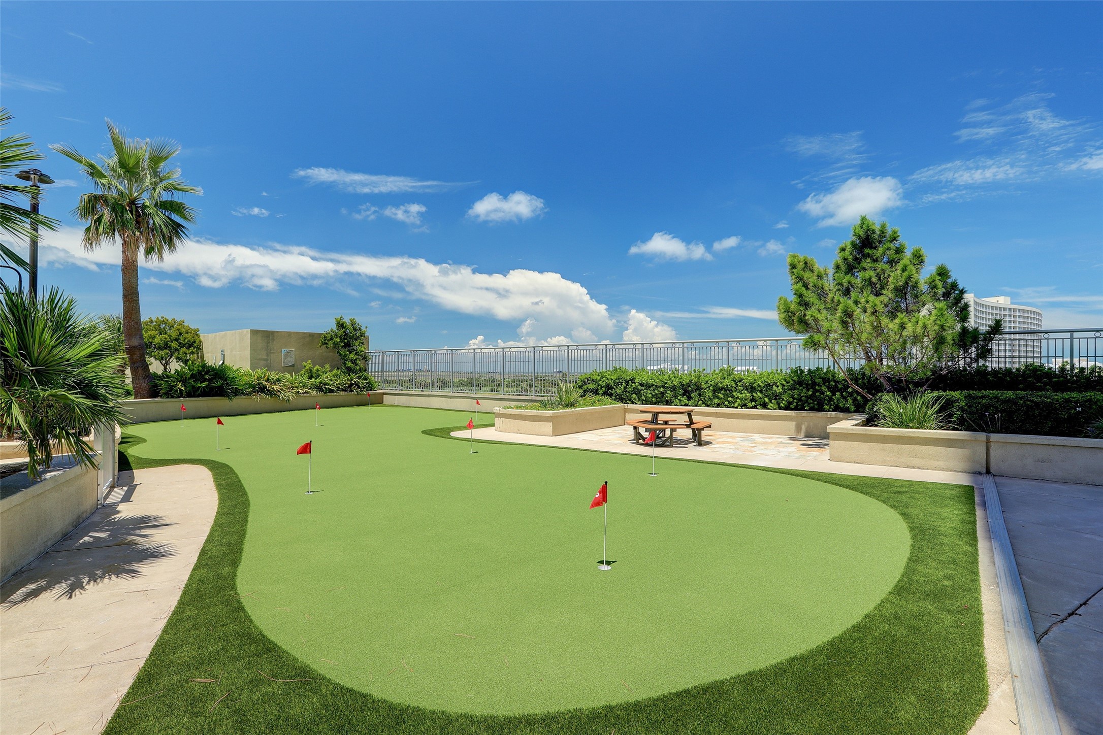Perfect for all ages, the putting green invites friendly competition and a chance to practice your short game beneath the coastal skyjust another way to enjoy everyday life at Palisade Palms