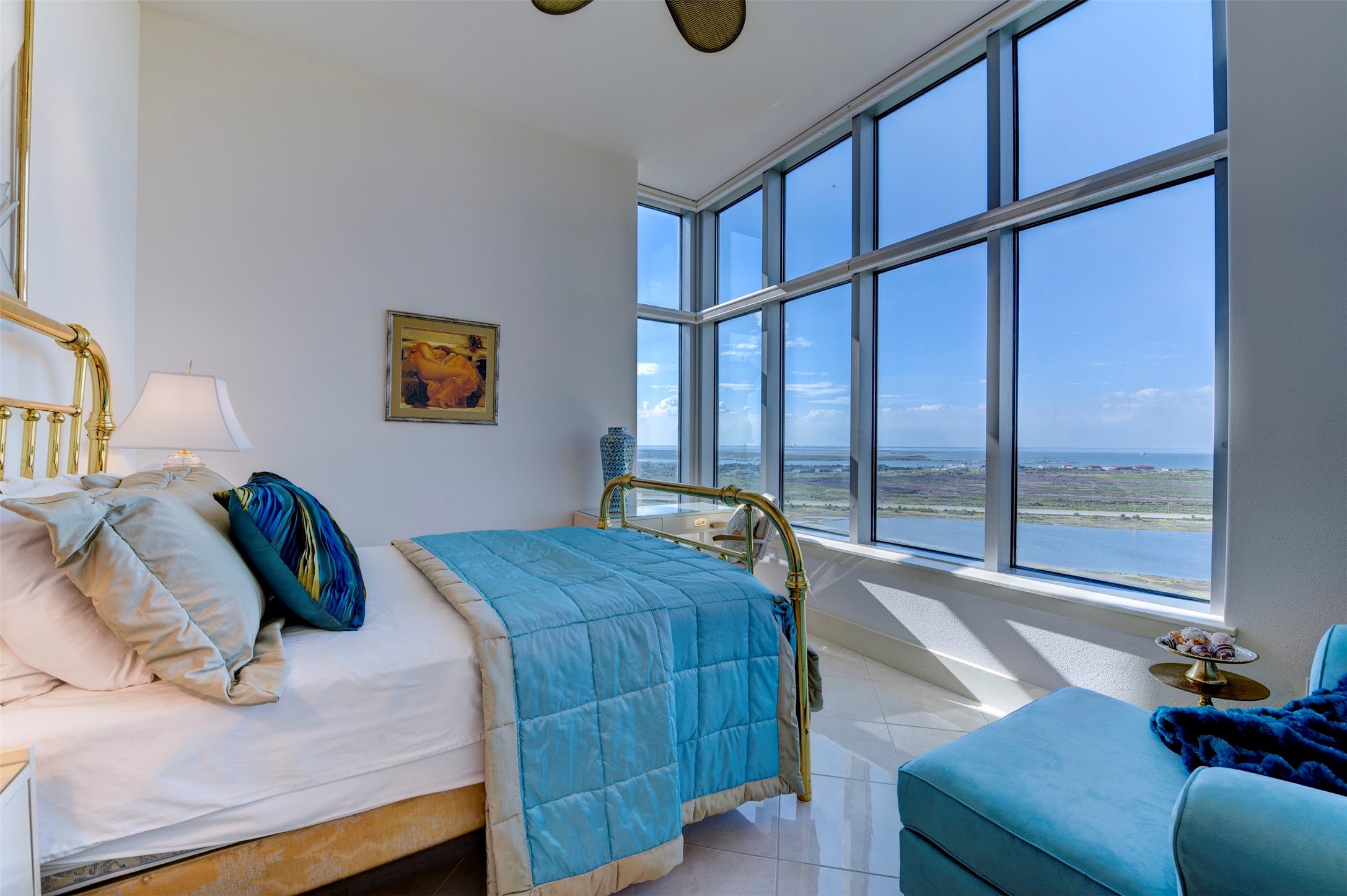 Third bath features a large glass-enclosed shower with rainfall showerhead and pebble-stone floor.
