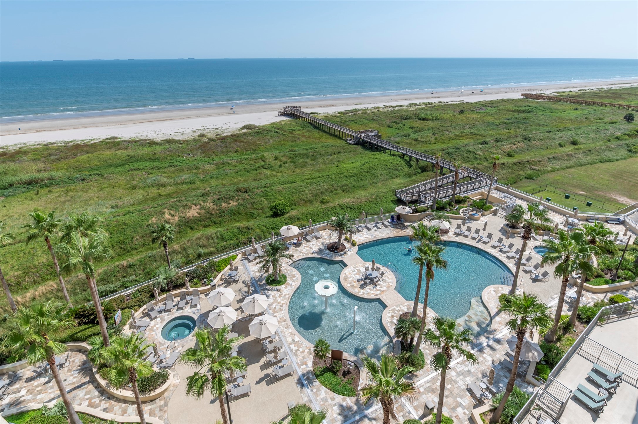 Beachfront views overlook the Gulf, beach, pool deck and Palisade Palms direct beach access