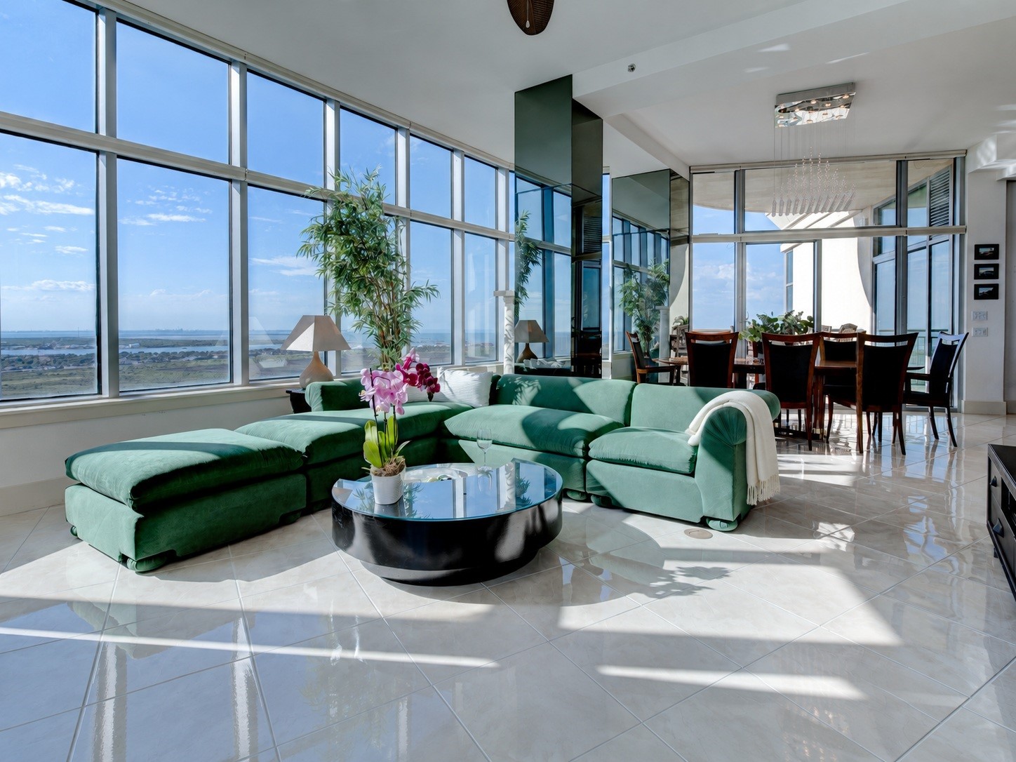 Penthouse living with soaring 11'4" ceilings, expansive living and dining areas, and walls of glass framing sweeping water and island views Penthouse living with soaring 11'4" ceilings, expansive living and dining areas, and walls of glass framing sweeping water and island views