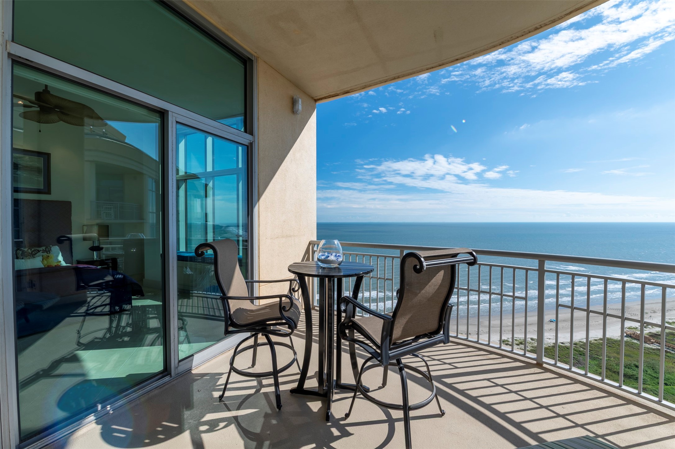 Beach-facing balcony offers open Gulf views with direct access from the second primary suite