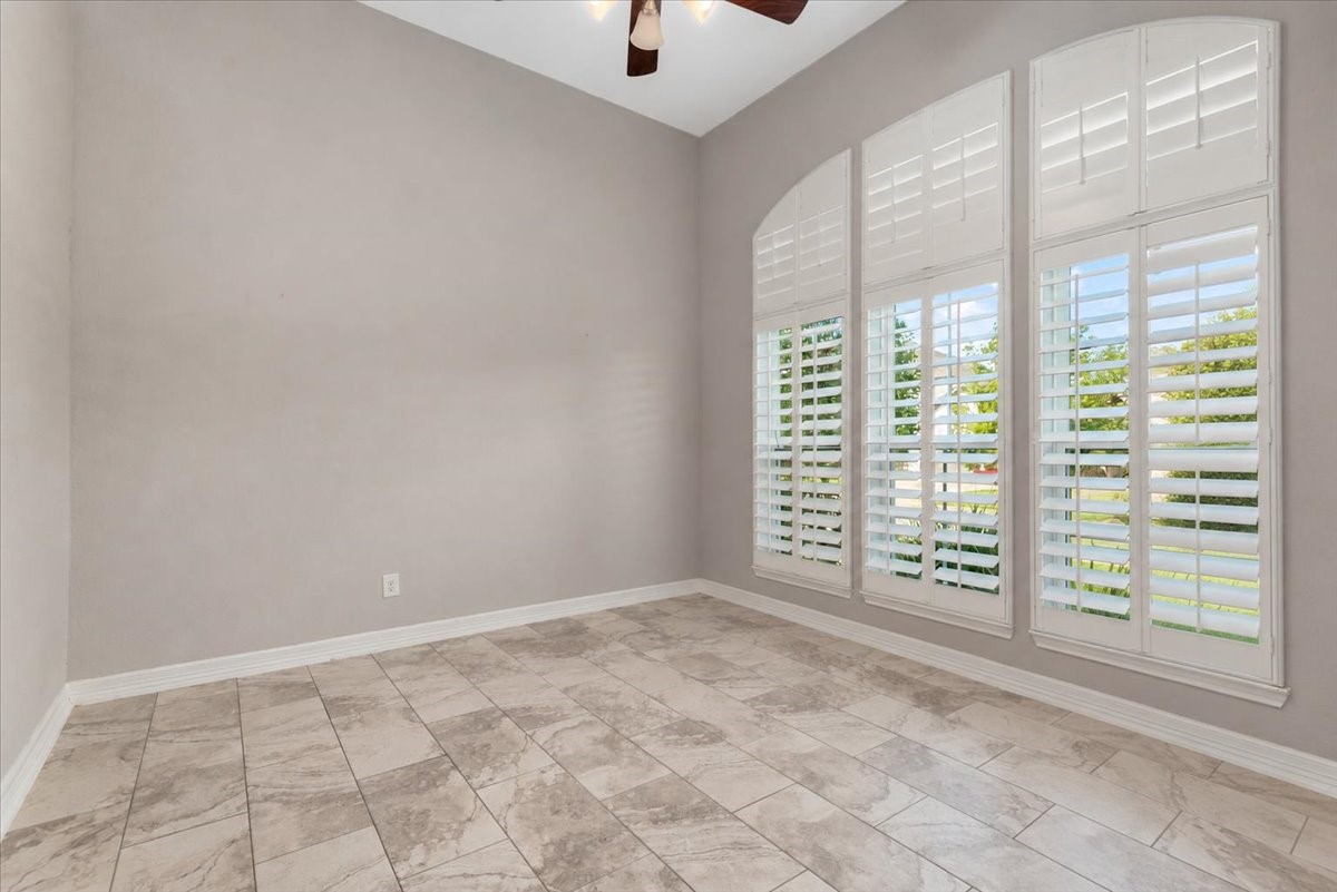 Home office located at the front of the home. Tile floors, shutters, ceiling fan. There is a full bathroom located outside of this room. Home office located at the front of the home. Tile floors, shutters, ceiling fan. There is a full bathroom located outside of this room.