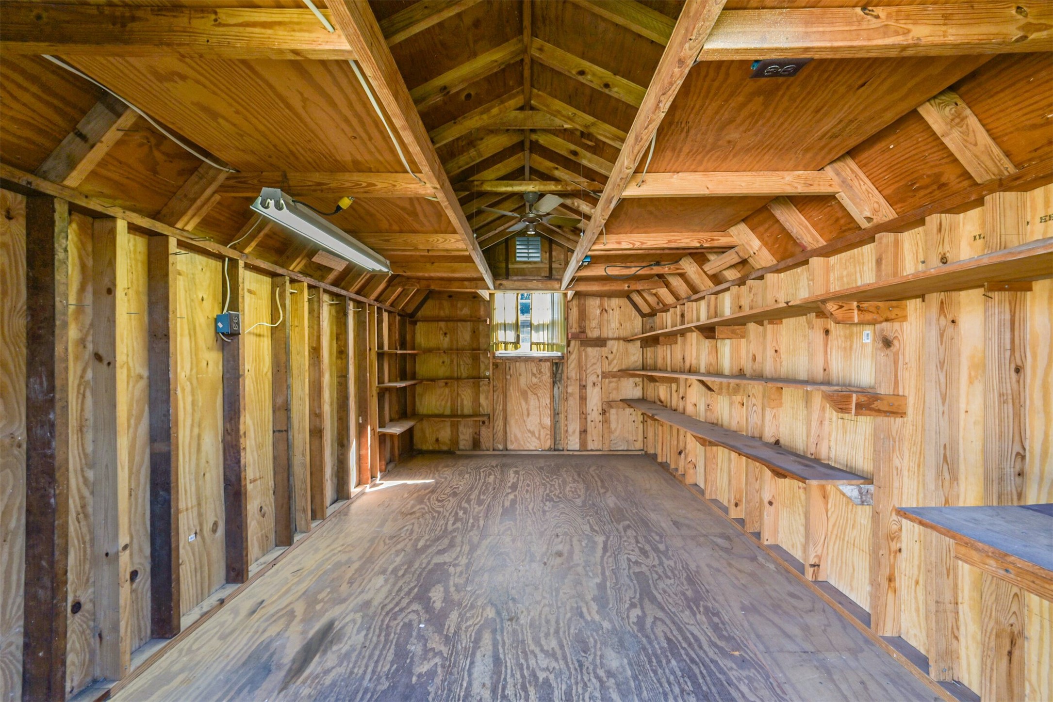 Built-in shelving, ventilation, and lighting make this a great place for storage or a work space.