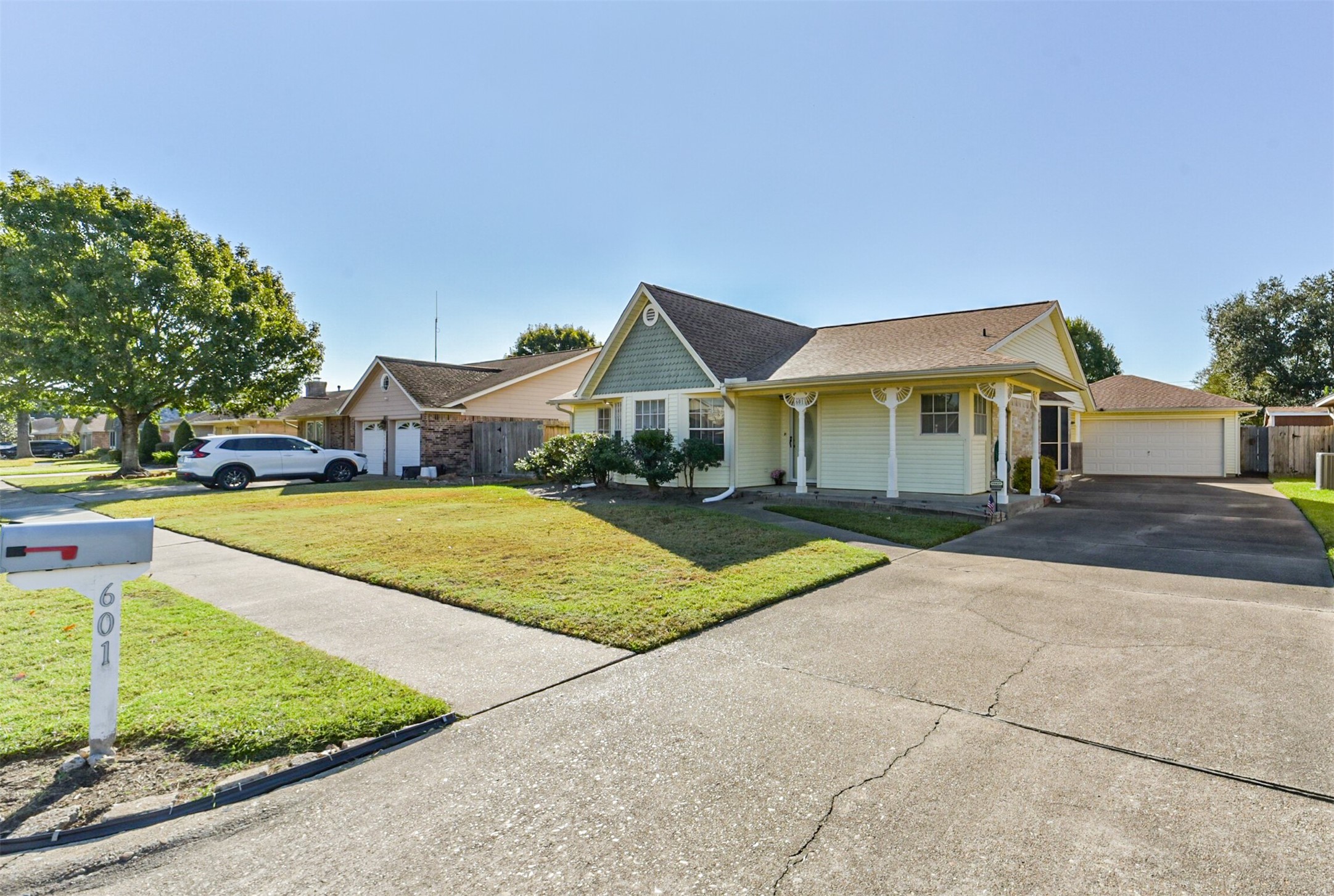 From this street view, you can see the detached garage and the long driveway, which provides plenty of parking. You can also see that the other homes on this quiet street are well-maintained.