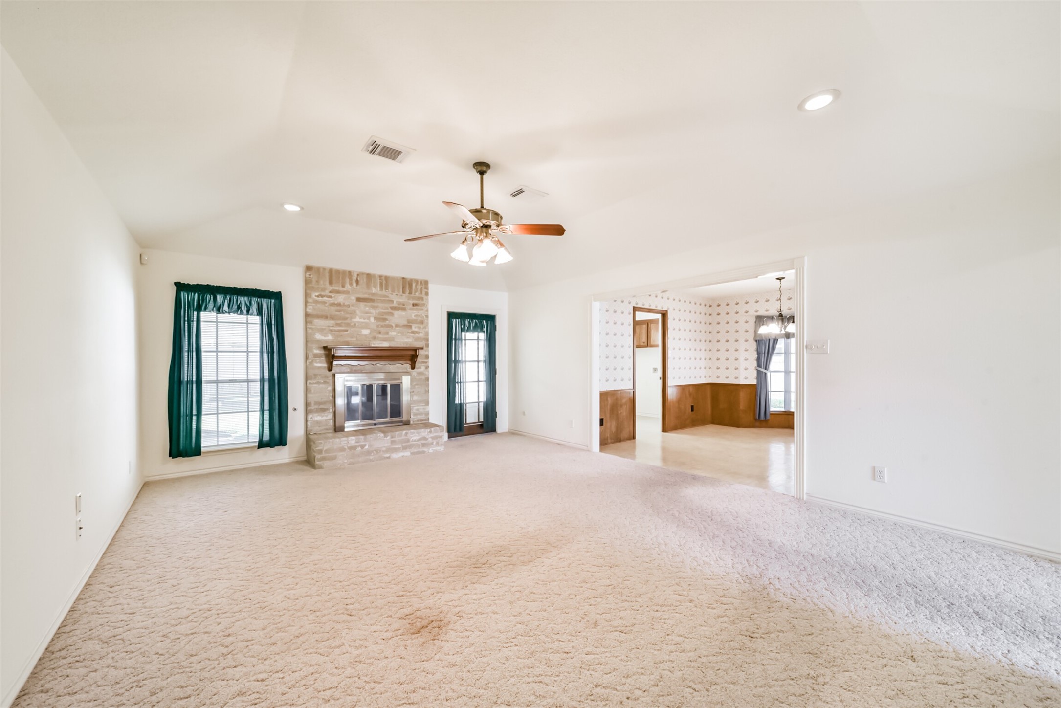 Imagine the possibilities in this spacious family room! Ready for new flooring and your personal touch, this inviting space offers a blank canvas to create the gathering place youve always envisioned. Bring your ideas and creativity to transform this room into a comfortable, stylish space perfectly suited to your lifestyle and needs.