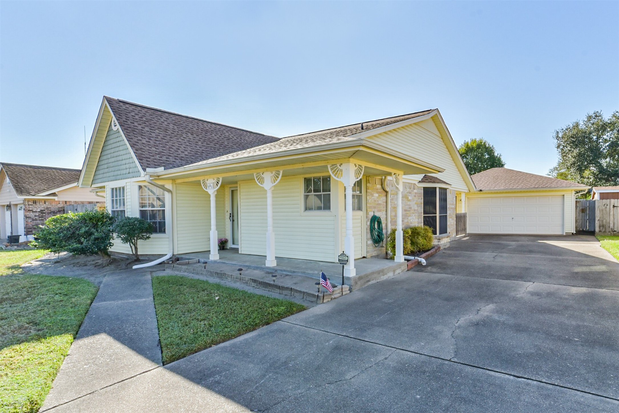Another view of the front of the house, the porch, garage, and driveway. Use your imagination to create your own special front porch.