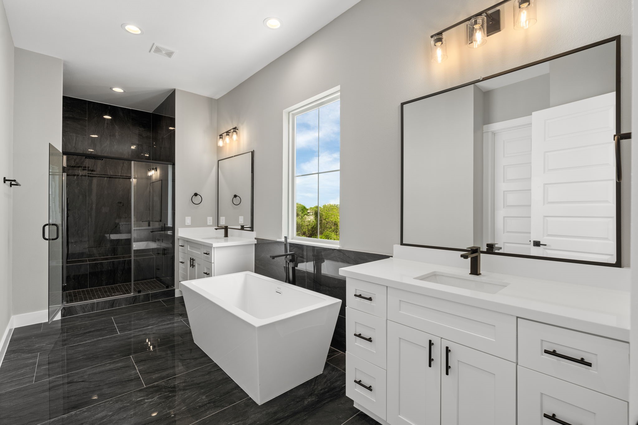 Incredible primary bathroom with soaking tub and standing shower