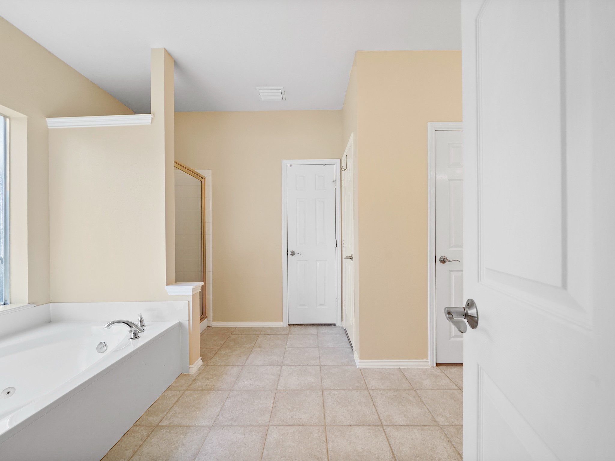 The primary bath continues the retreat with a dual-sink vanity, jetted tub, and separate shower. Its thoughtful layout offers room to prepare for the day and unwind when its done.
