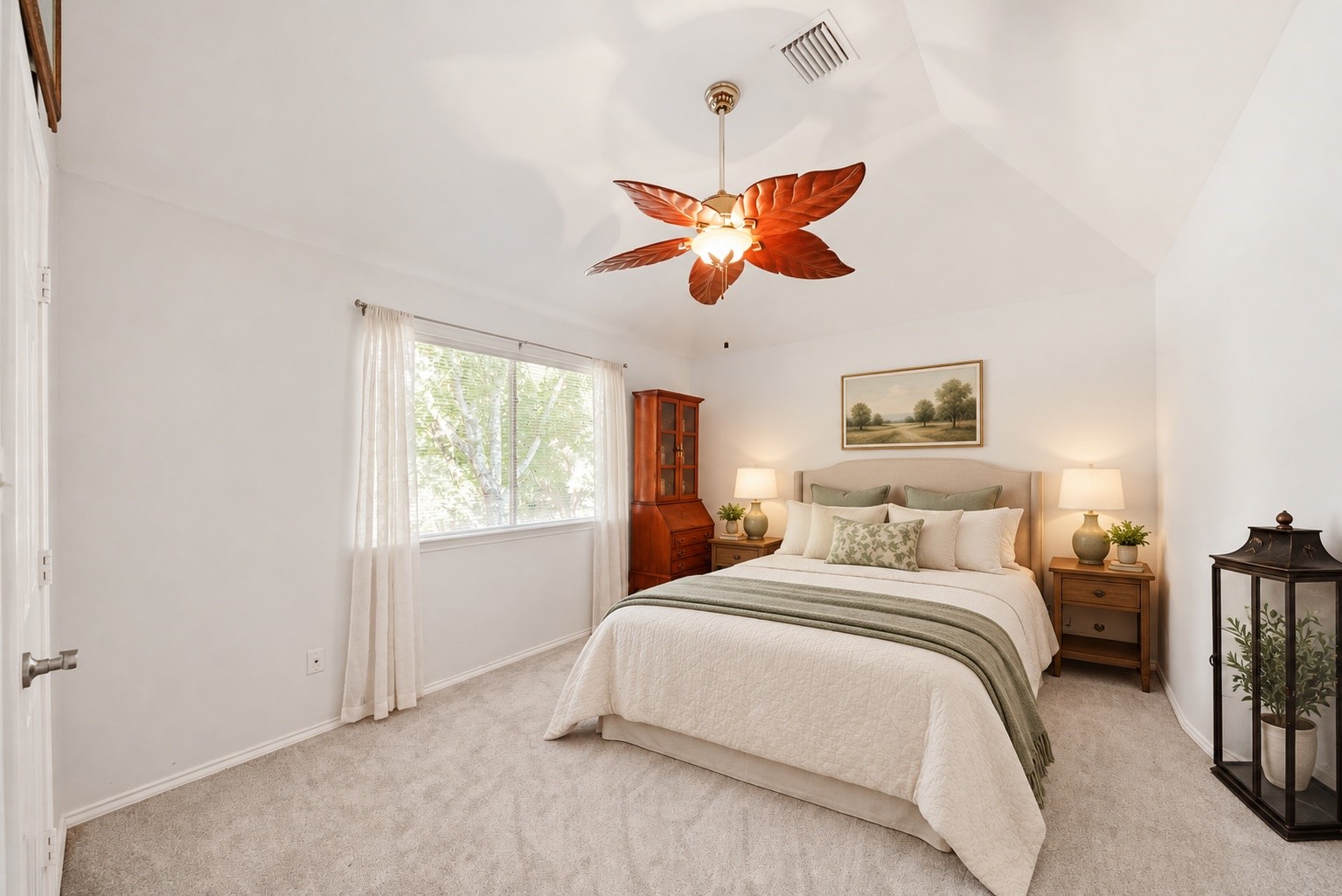 Virtually Staged: This secondary bedroom has been styled as a welcoming guest retreat. A vaulted ceiling and soft natural light create an inviting space for visitors to settle in and feel at home.
