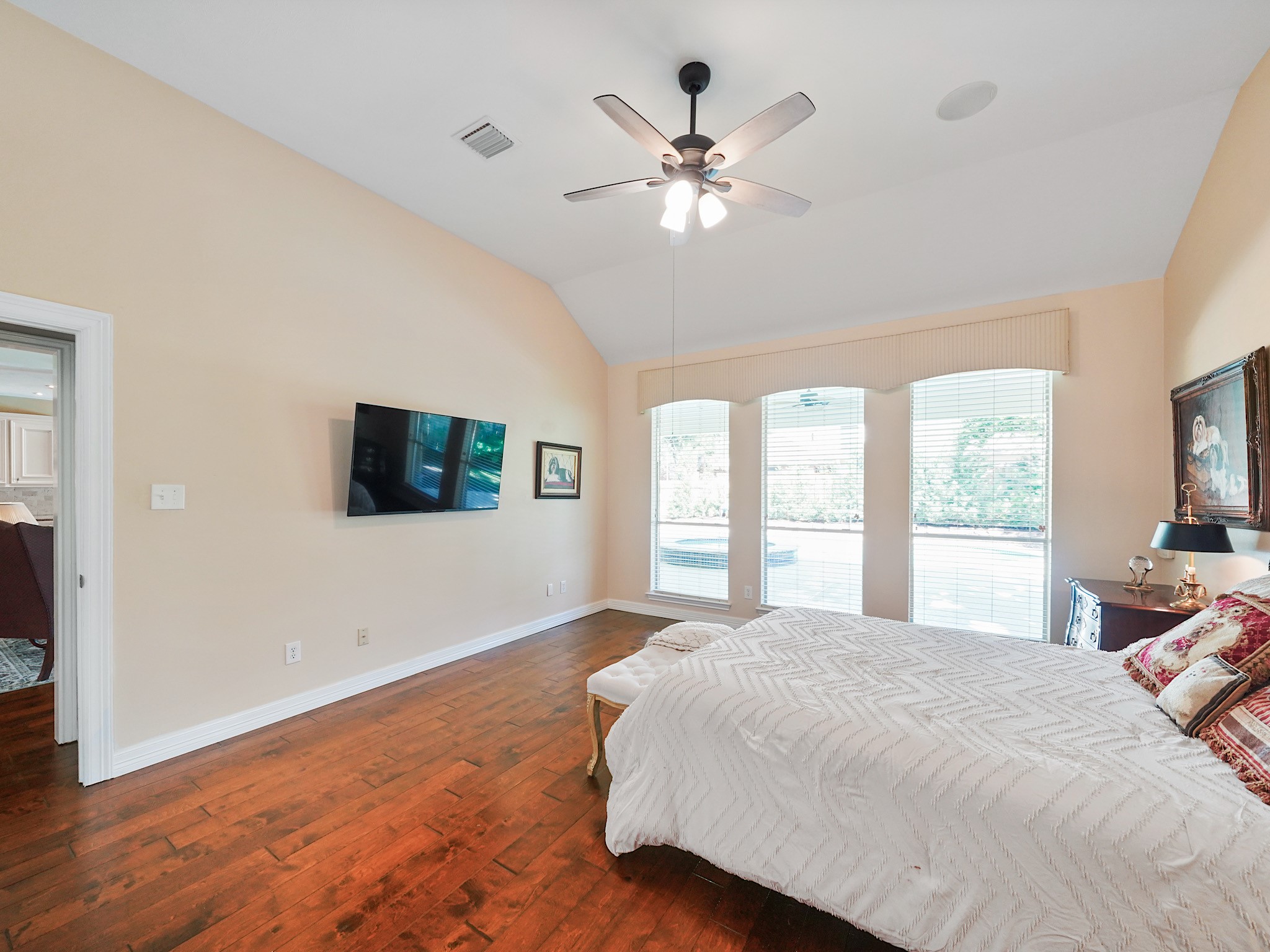 Sunlight filters through the primary bedroom windows, creating a bright and restful atmosphere. Imagine easing into the morning here or settling in for a quiet evening at home.