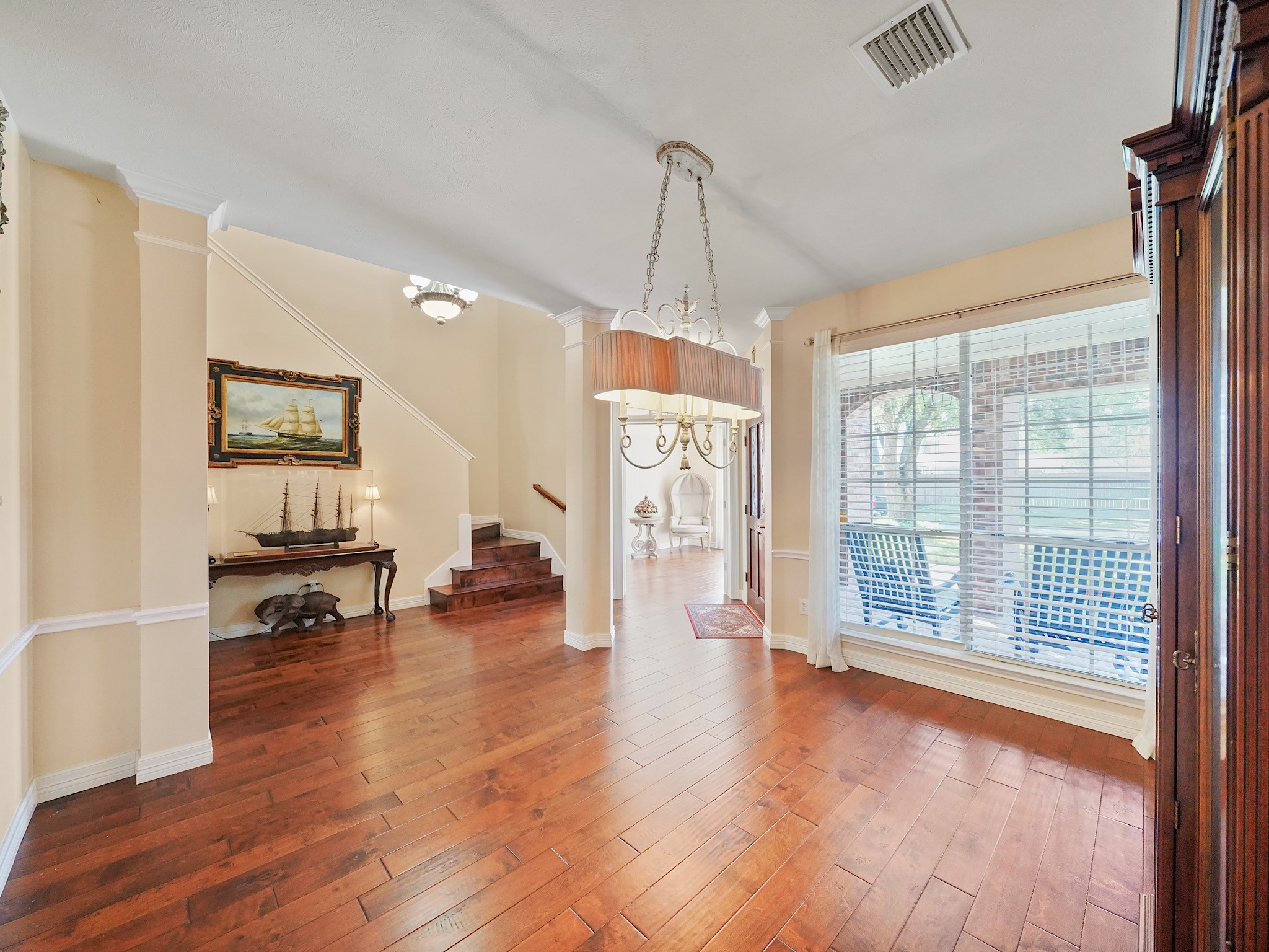 Just off the entry, the formal dining room offers an elegant setting for holidays, celebrations, and evenings around the table. A large window fills the room with natural light, while the wood flooring adds warmth.