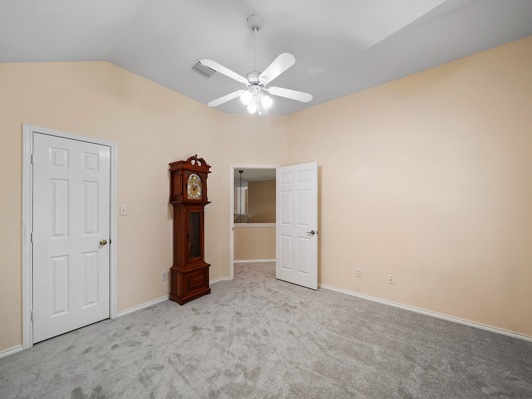 This upstairs secondary bedroom offers a comfortable place to settle in, with room for a bed, dresser, and the personal touches that make it feel like home.