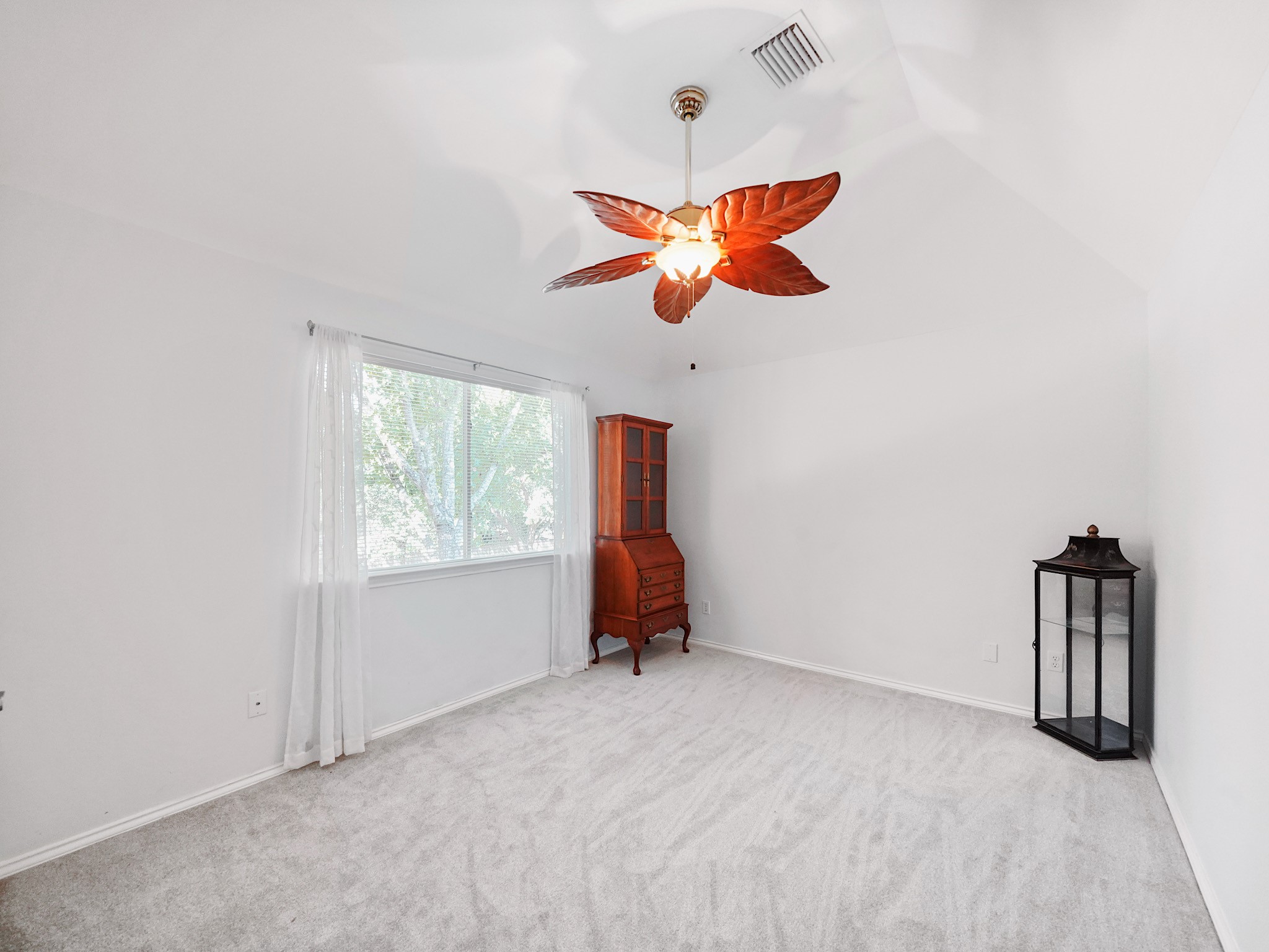 This secondary bedroom offers a welcoming setting for guests or everyday living. A window brings in natural light, while the neutral backdrop is ready for your own style.