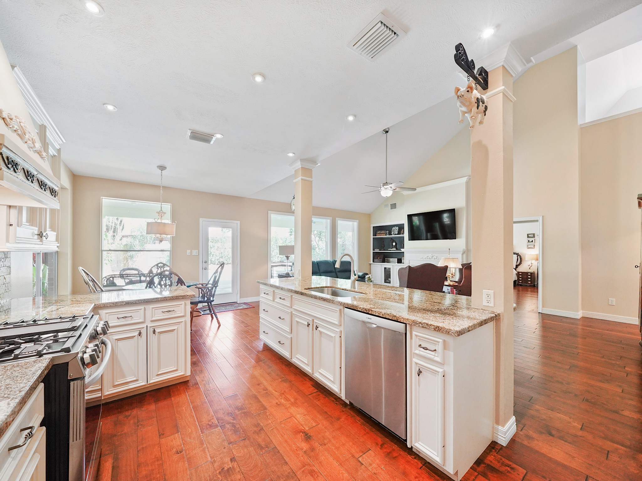 A gas range, plentiful cabinetry, and room to prep make this kitchen as practical as it is inviting. The open setting keeps the cook connected to the surrounding living and dining areas.