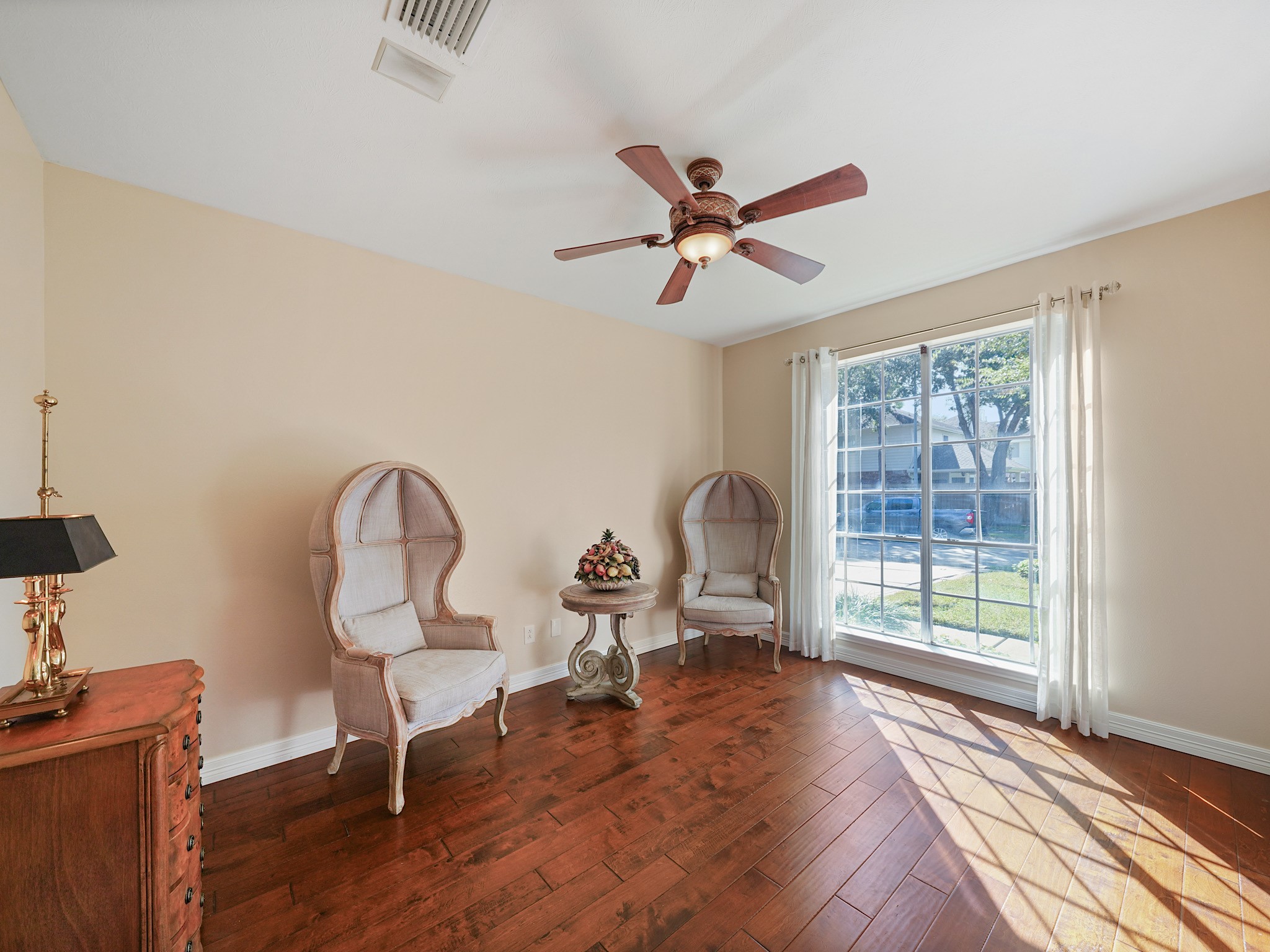 This versatile room offers a peaceful setting for a home office, reading room, or creative space. A large window brings in natural light, creating an inviting place to spend the day.