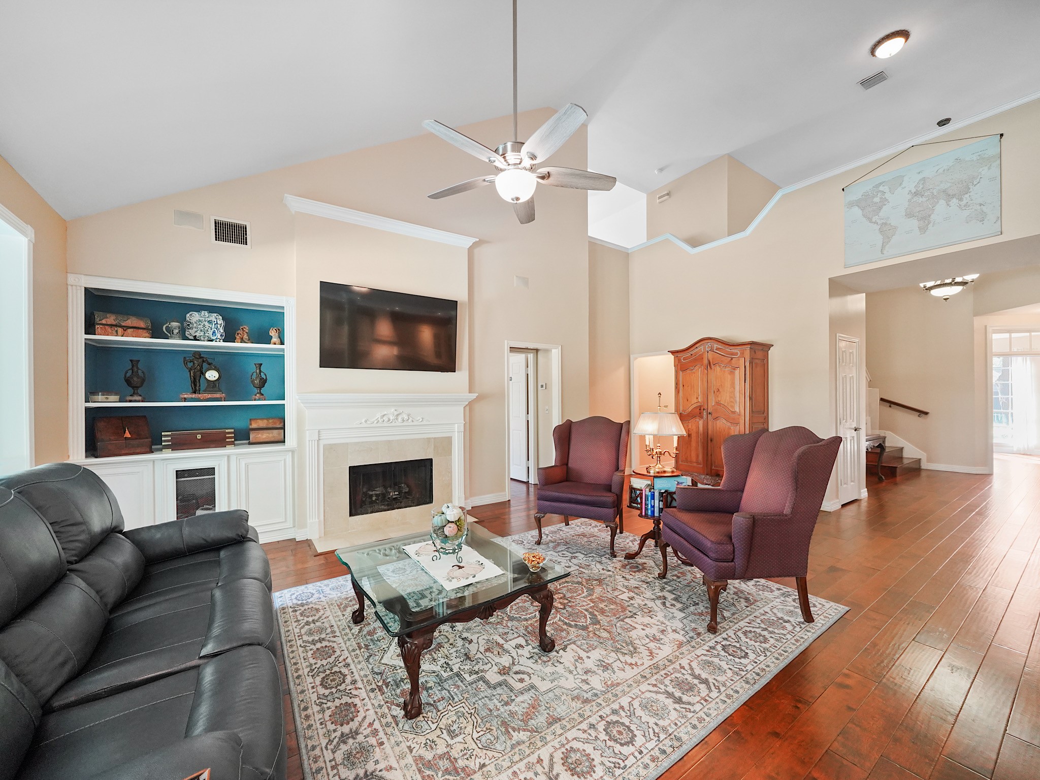 A fireplace creates a cozy focal point in the family room, with built-in shelving nearby to display favorite books and keepsakes. Imagine winding down here at the end of the day.