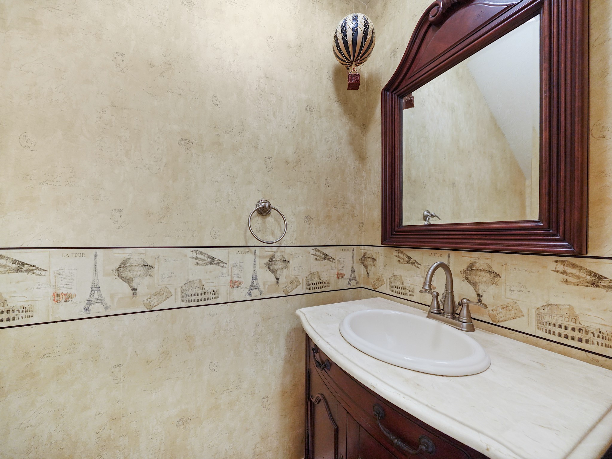 The downstairs powder room is conveniently located for guests and everyday use, with decorative details that give the space its own personality.
