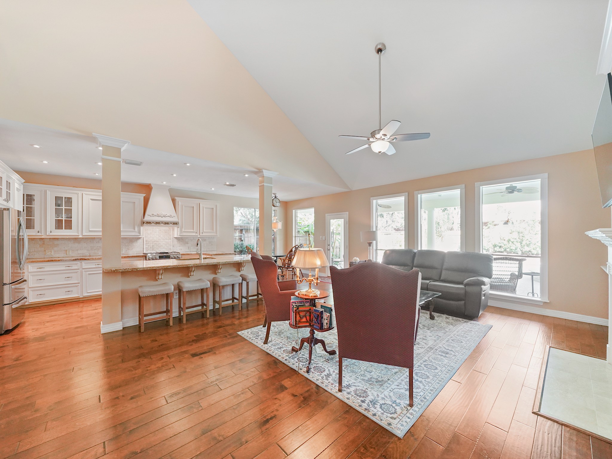 The family room welcomes you with an open layout, warm wood flooring, and a seamless connection to the kitchen. Gather here for relaxed evenings while enjoying a view of the backyard.