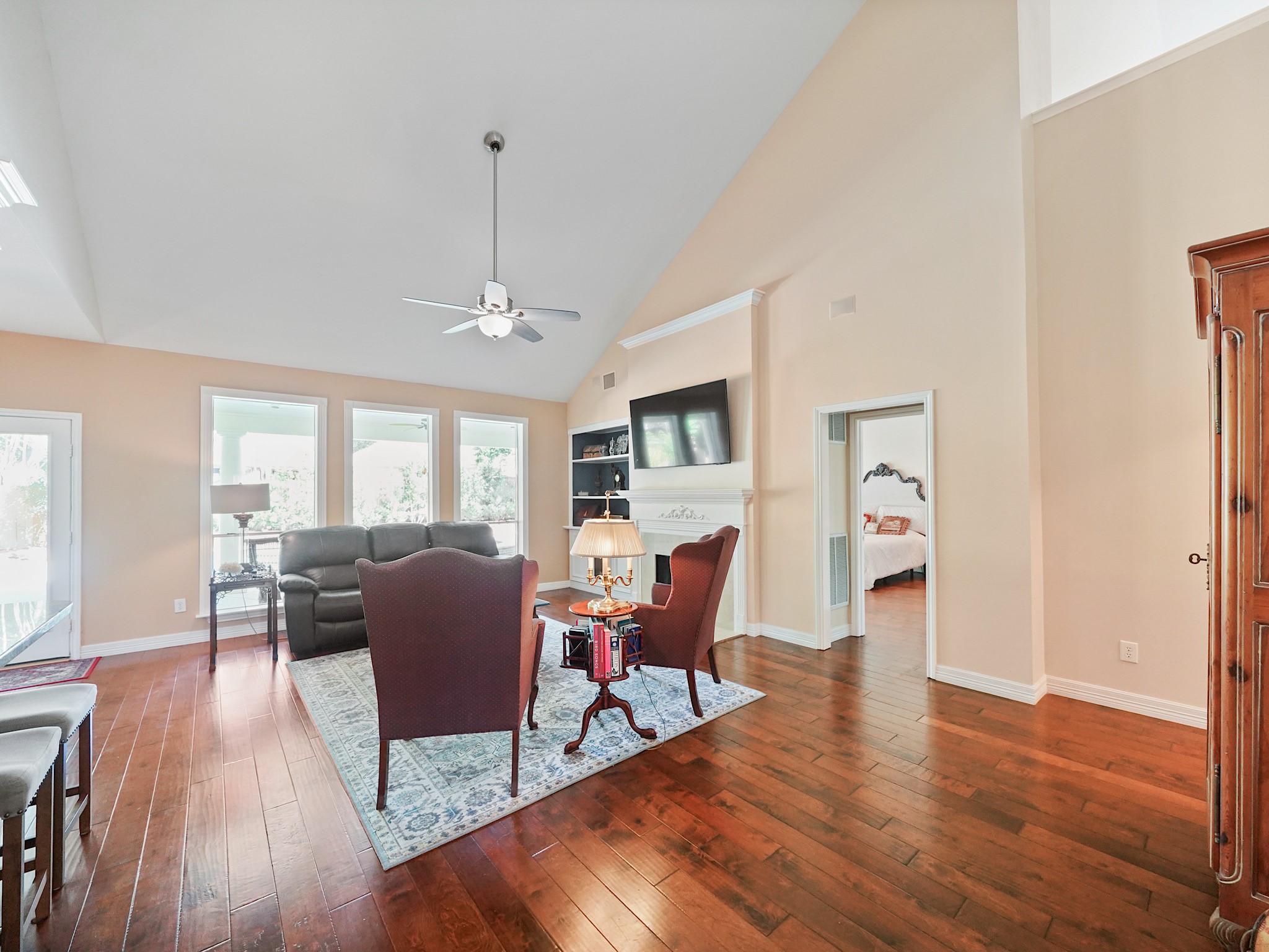 High ceilings and a wall of windows give the family room an airy, inviting feel. Theres plenty of room to settle in for a movie night or catch up with friends after dinner.