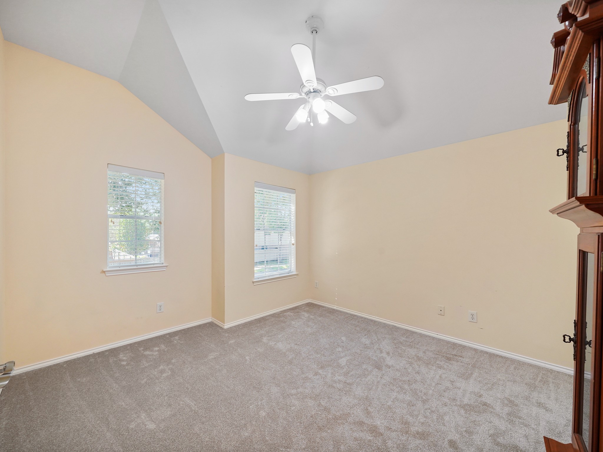 Another view of the bedroom highlights its windows and generous floor space. Create a cozy bedroom with room for a reading chair, desk, or favorite collection.