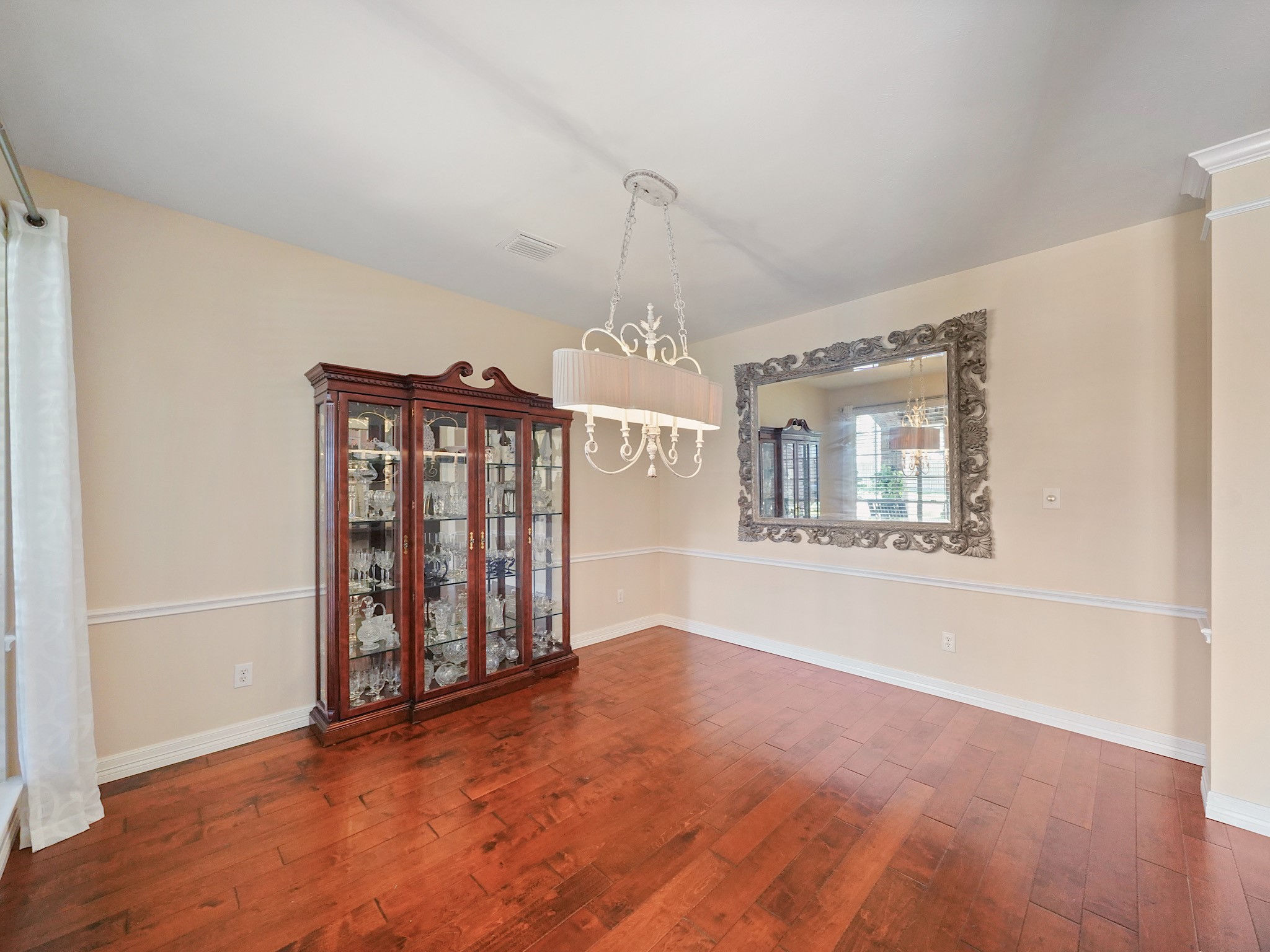Whether hosting a special occasion or enjoying a quiet dinner, the formal dining room provides a lovely backdrop. Its open feel and warm flooring create a space ready to be made your own.