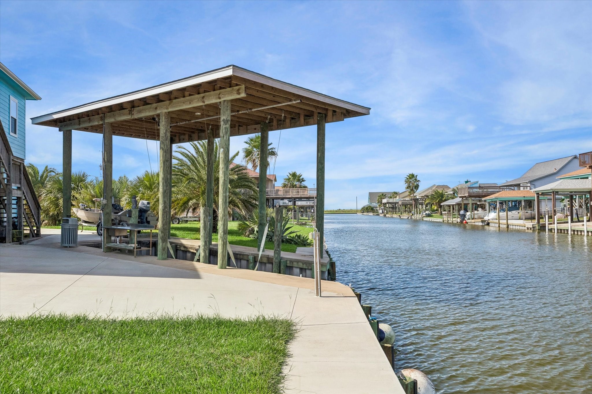Waterfront oasis with a private covered boat dock overlooking a serene canal, perfect for boating enthusiasts and nature lovers.