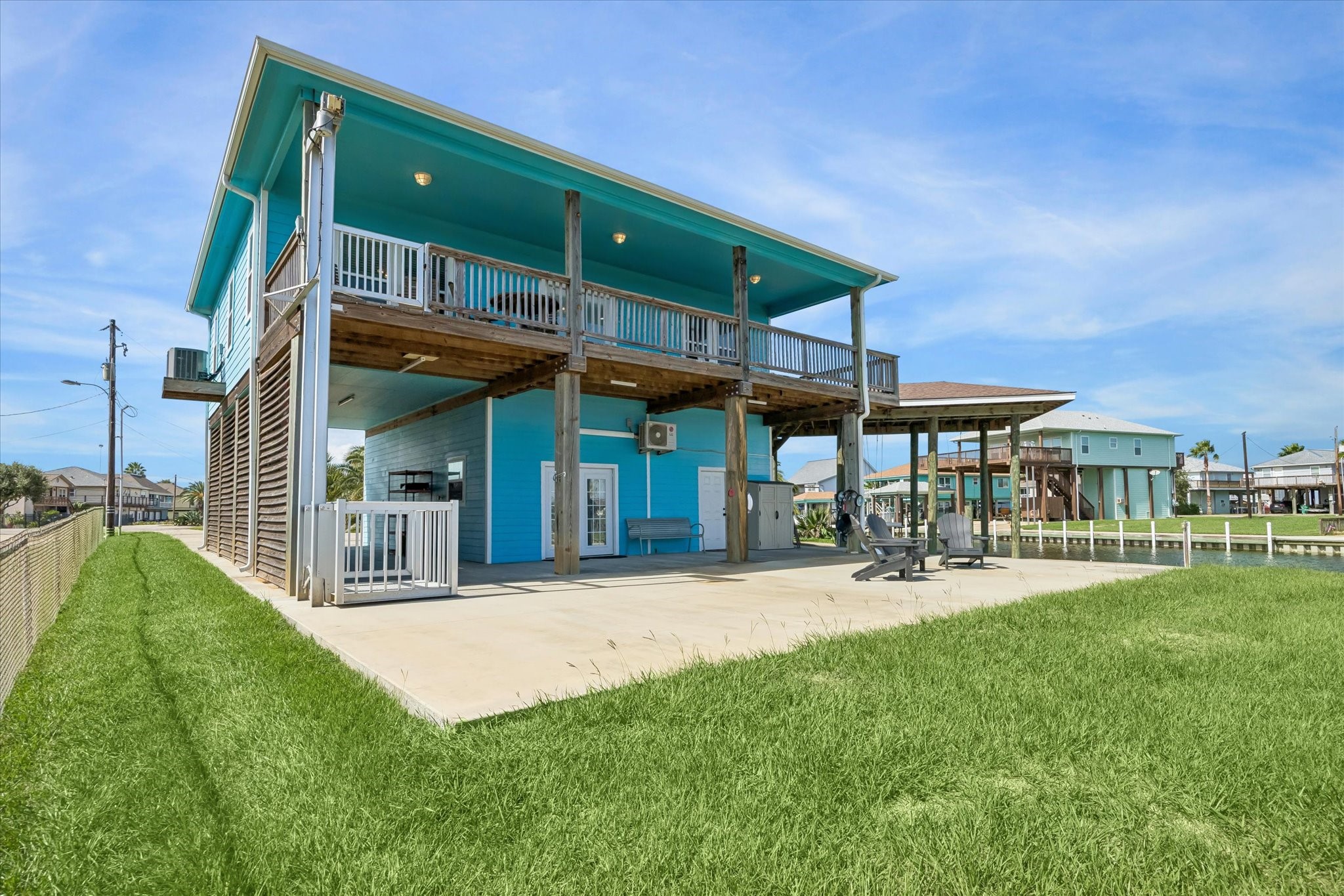 Vibrant coastal home boasting an elevated design with an expansive deck and spacious outdoor entertaining area.