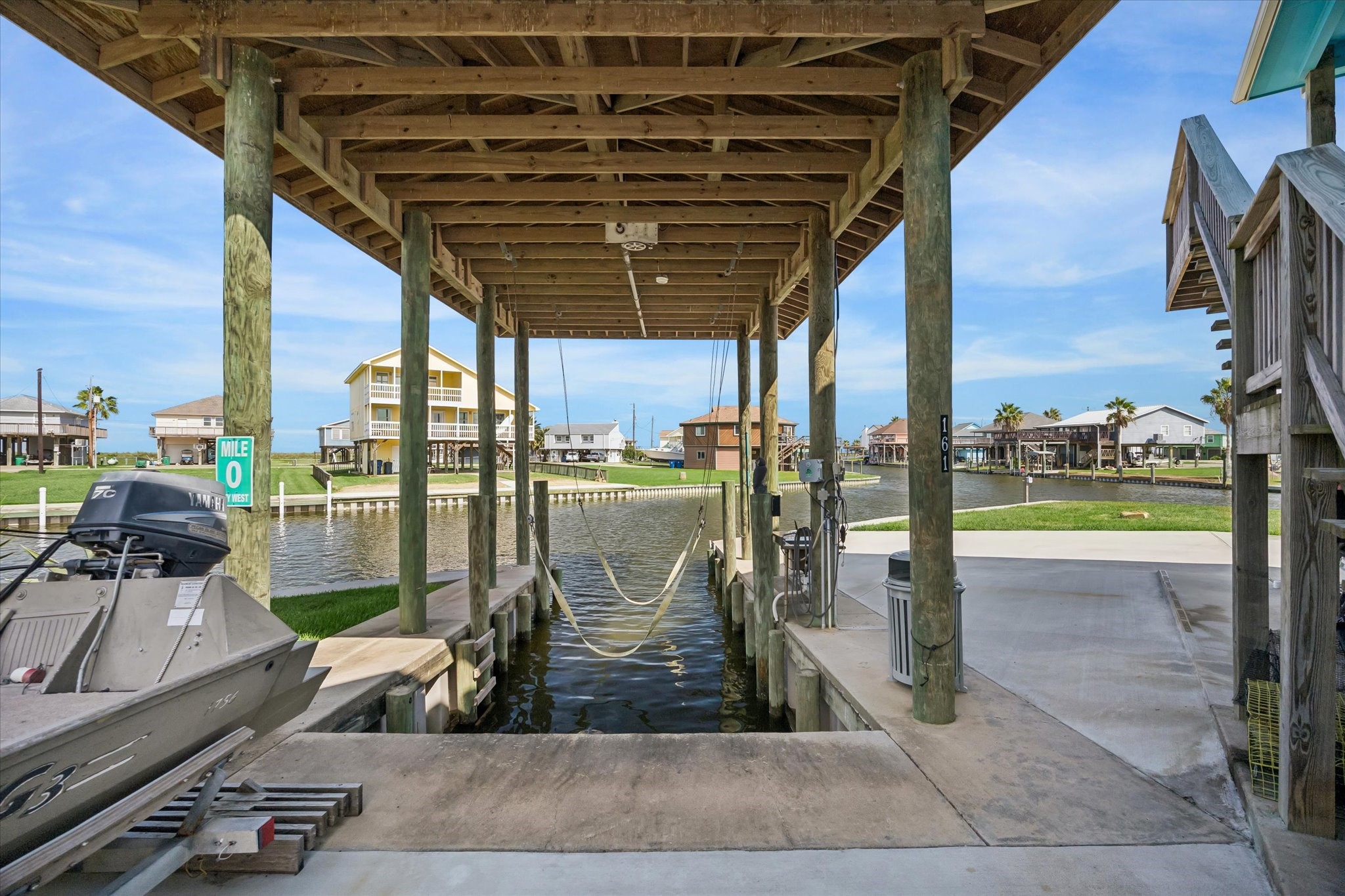 Charming waterfront property with a covered boat lift, offering direct canal access and stunning views. Perfect for boating enthusiasts seeking a serene coastal lifestyle.
