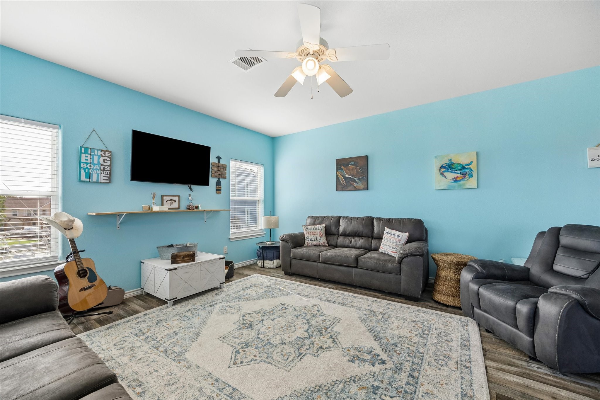 Bright and inviting living room with a soothing blue accent wall.