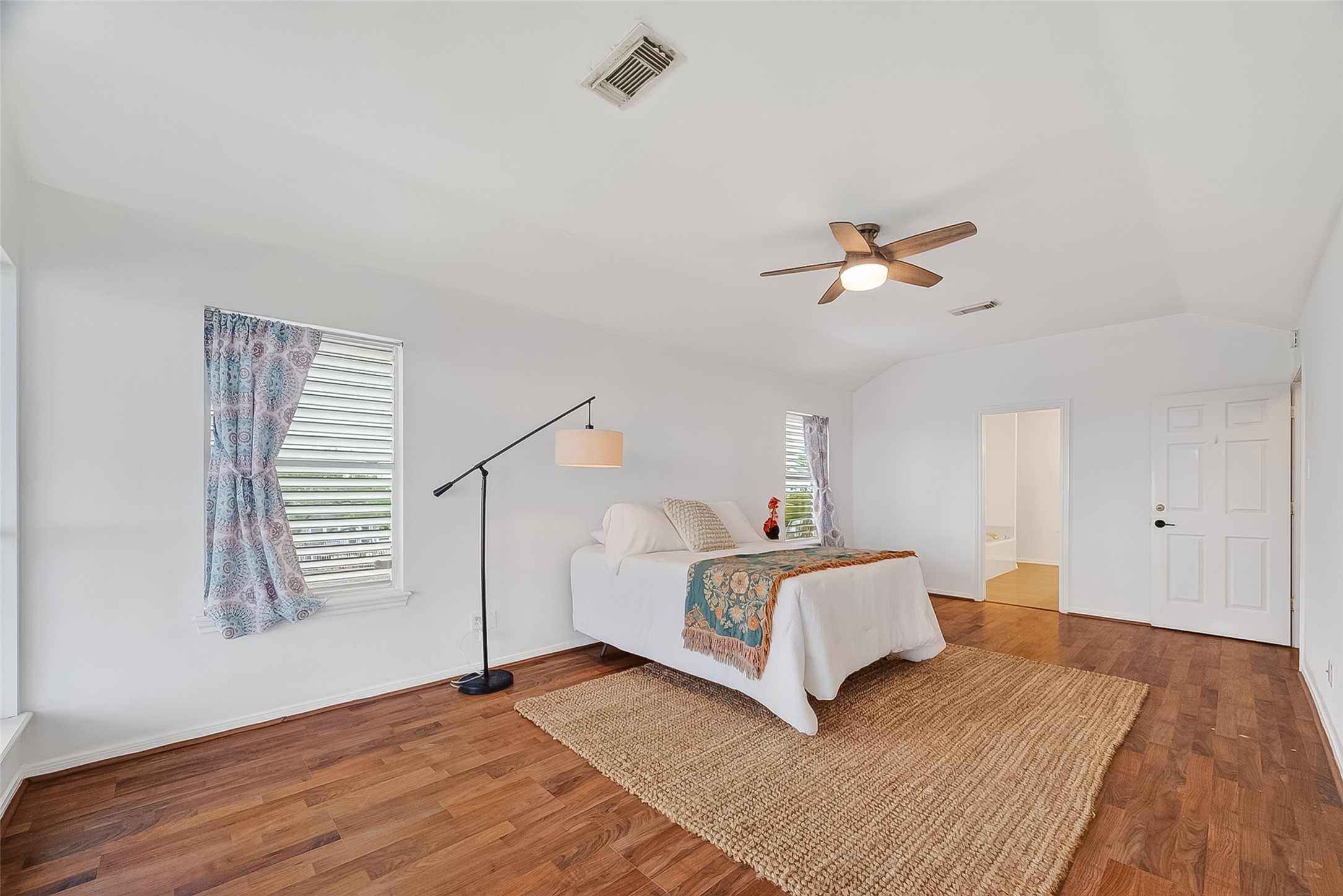 Tons of natural light in the primary bedroom! Here is Looking towards the ensuite bathroom and walk in closet