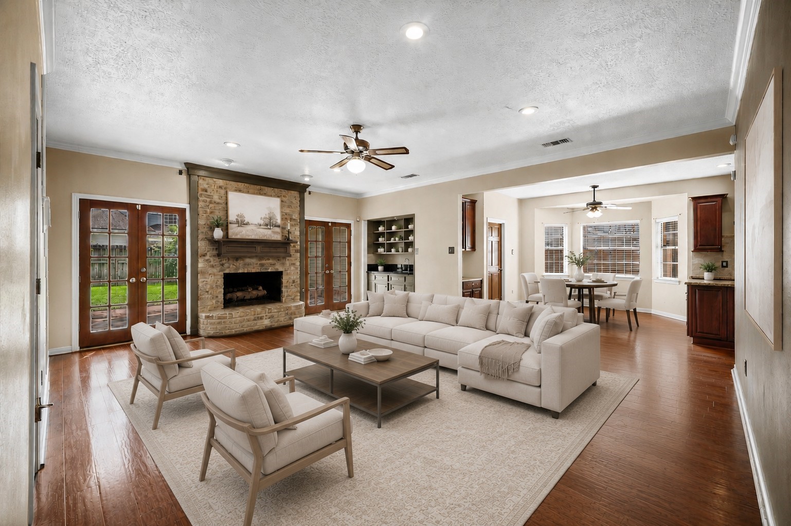 Photo is virtually staged to include furniture layout and decor possibilities. Additional shelving virtually added over wet bar for design inspiration.