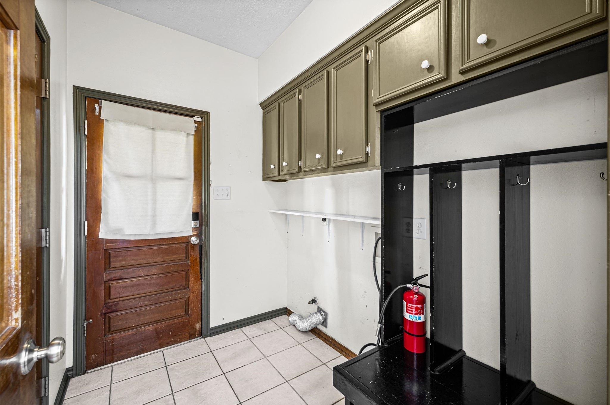 Laundry room located downstairs with built-in nook for backpacks or bags and all the shoes! The half bath is also located off the laundry room.