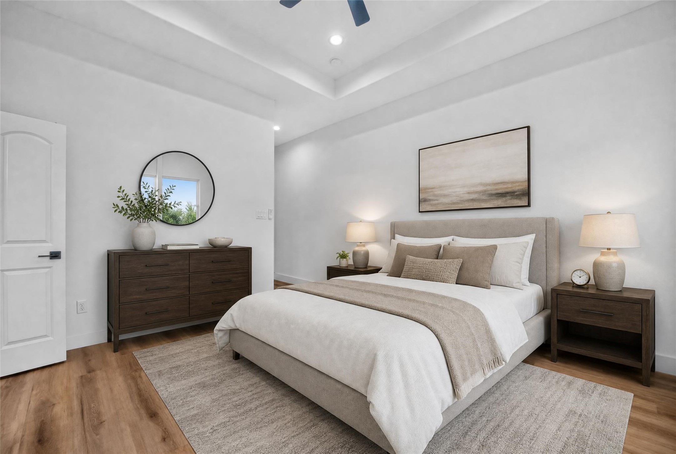 Unwind in this spacious second-floor primary suite featuring a recessed ceiling and ceiling fan, creating an airy, comfortable space to relax and recharge. Your modern retreat awaits. Unwind in this spacious second-floor primary suite featuring a recessed ceiling and ceiling fan, creating an airy, comfortable space to relax and recharge. Your modern retreat awaits.