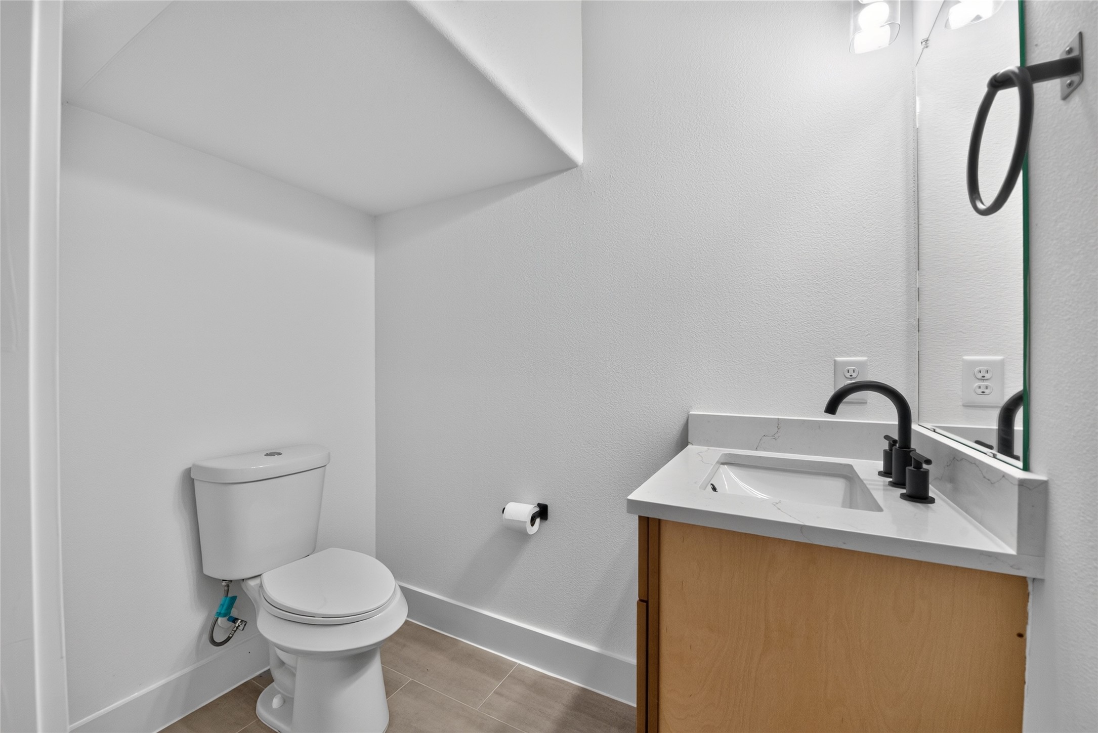 A generously sized half bath on the main floor, thoughtfully designed for everyday convenience and visiting guests.
