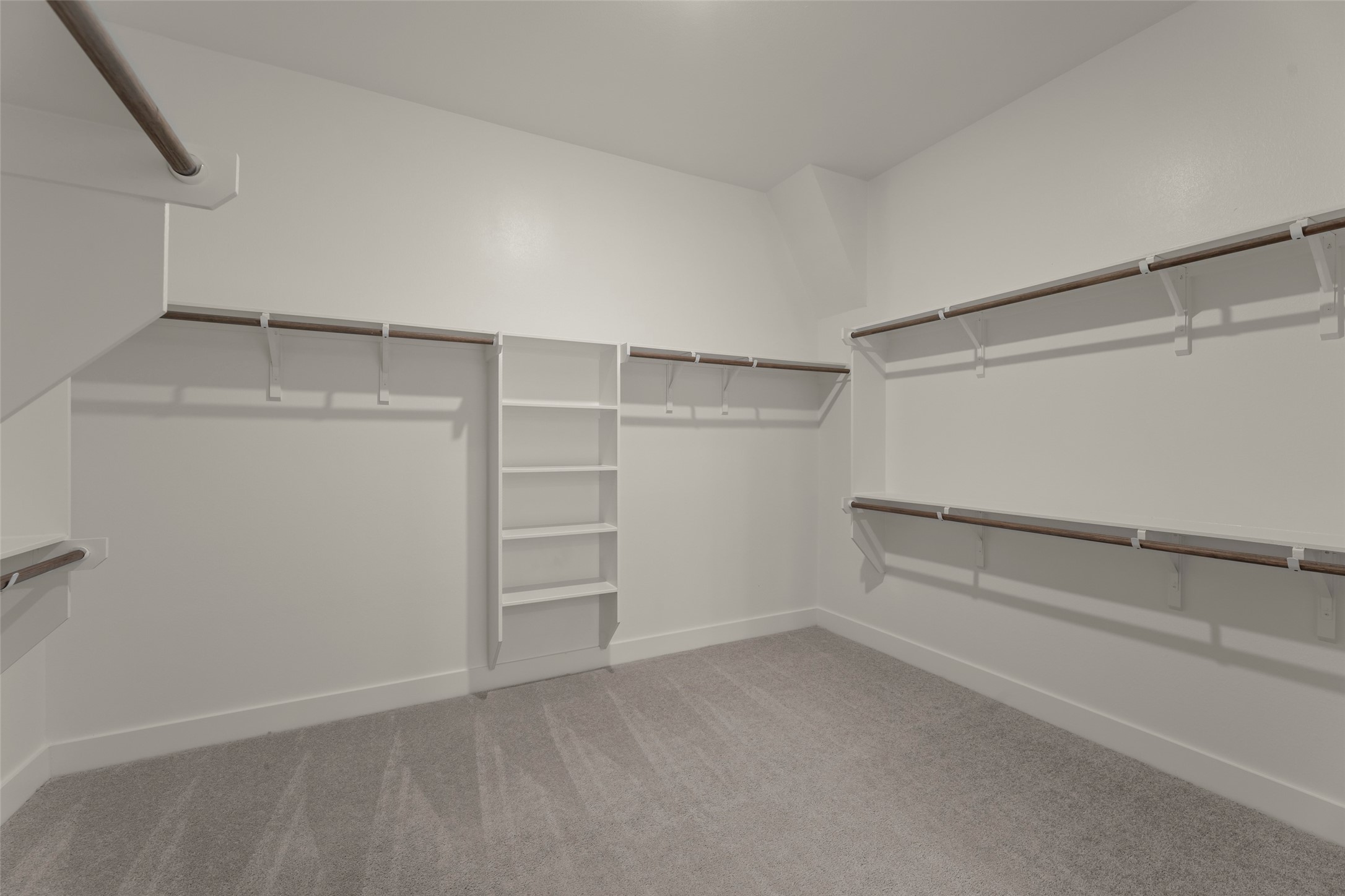 Huge walk-in closet with ample shelving and hanging space.