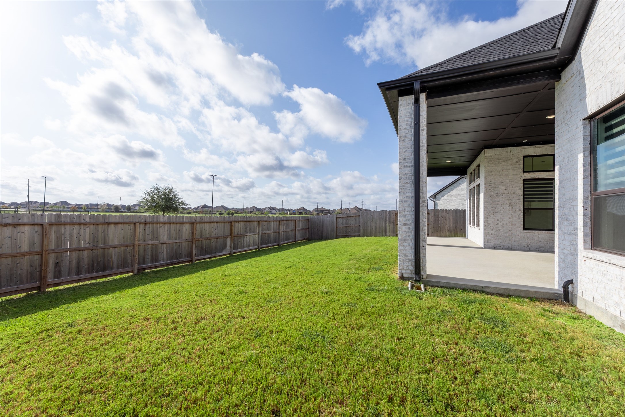 Lush green lawn and a spacious covered patio, perfect for outdoor relaxation and entertaining.